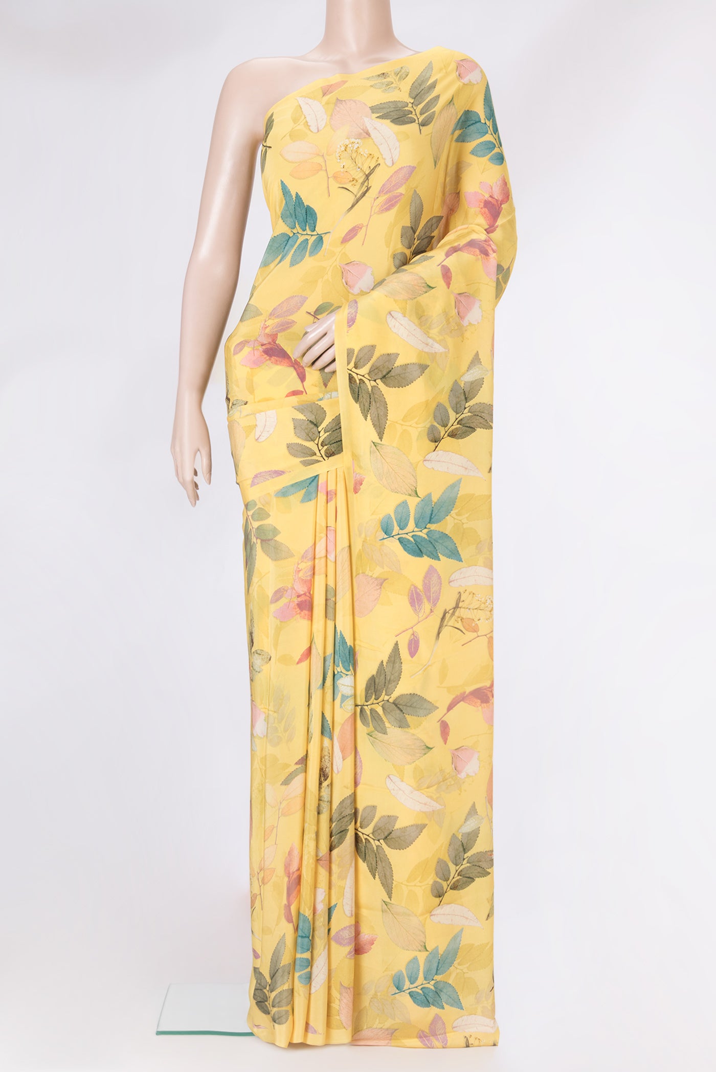 Yellow Crepe Saree with Printed design on the body and Plain Border.  displayed on a mannequin
