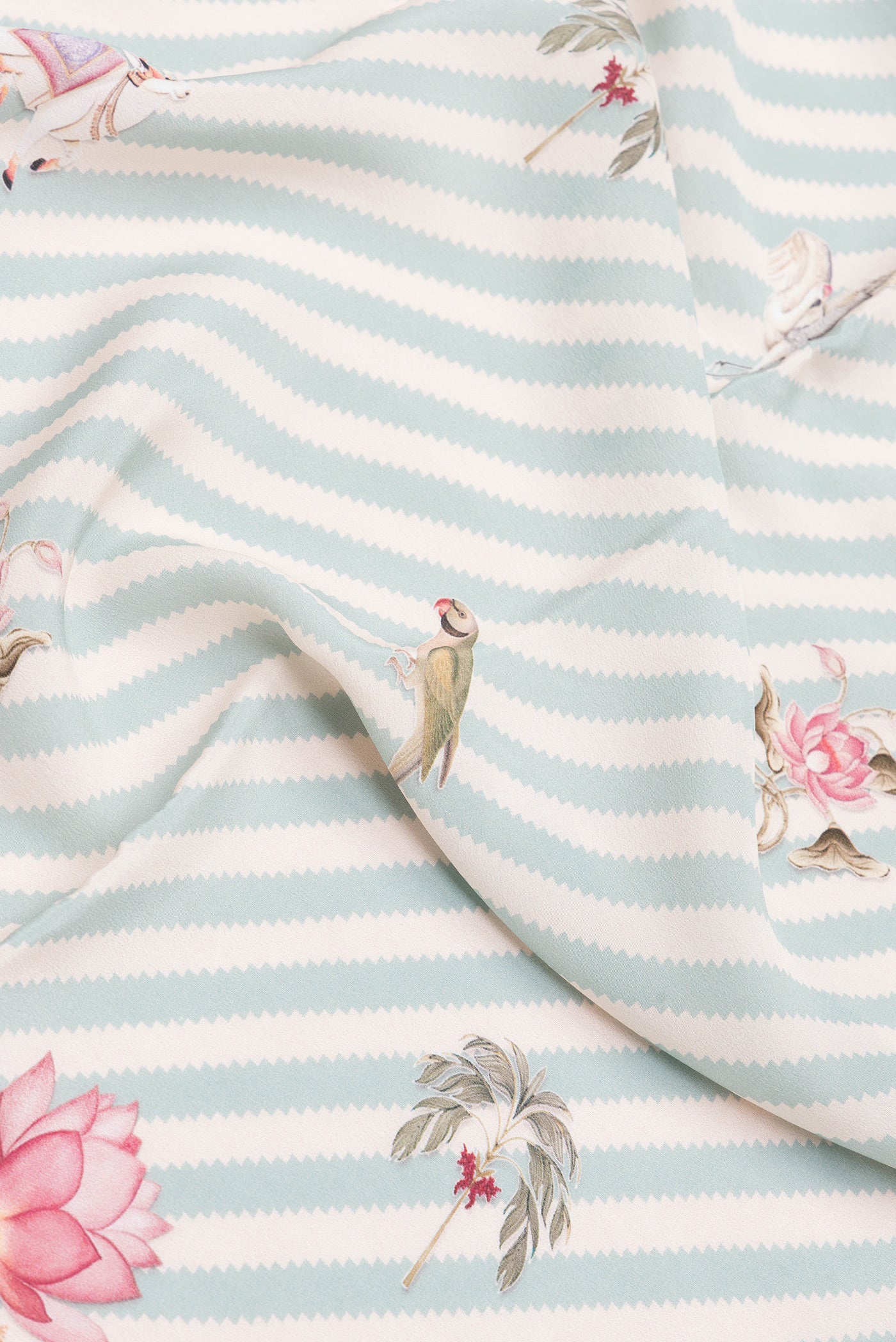 Close up of Light Blue Dual Tone Mysore Crepe Saree with Printed design on the body and Plain Border.  displaying folds