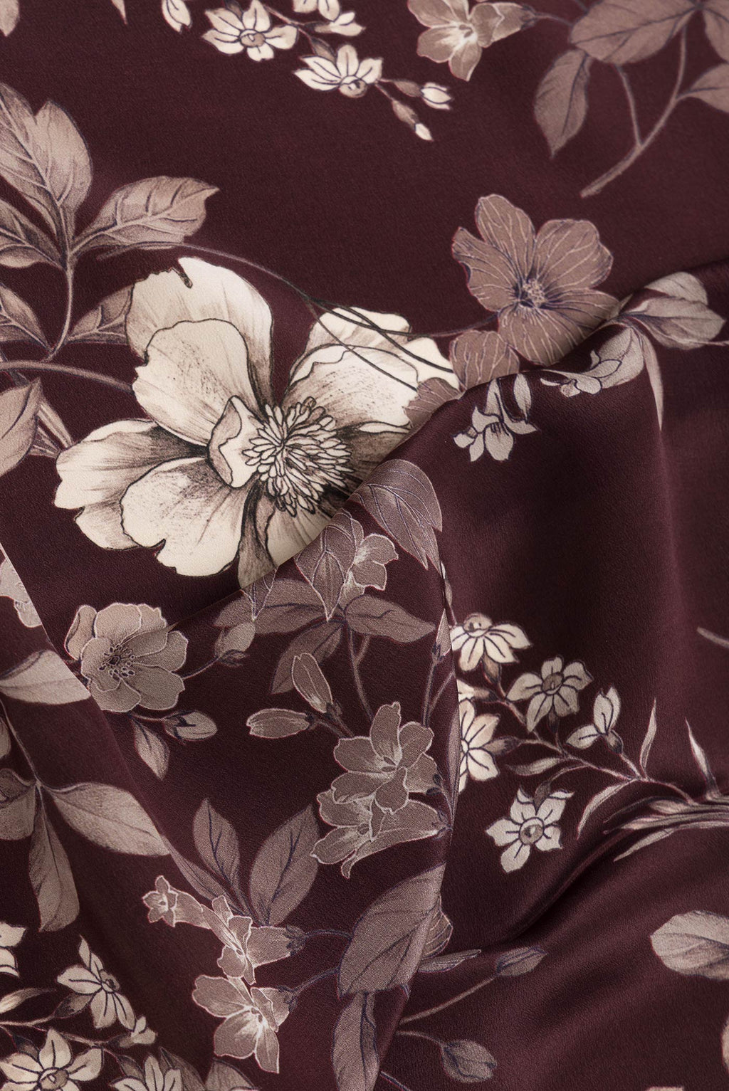 Close up of Maroon Dual Tone Mysore Crepe Saree with Printed design on the body and Without Border.  displaying folds
