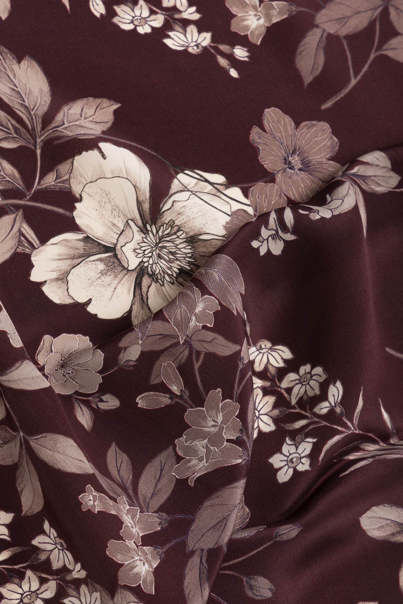 Close up of Maroon Dual Tone Mysore Crepe Saree with Printed design on the body and Without Border.  displaying folds