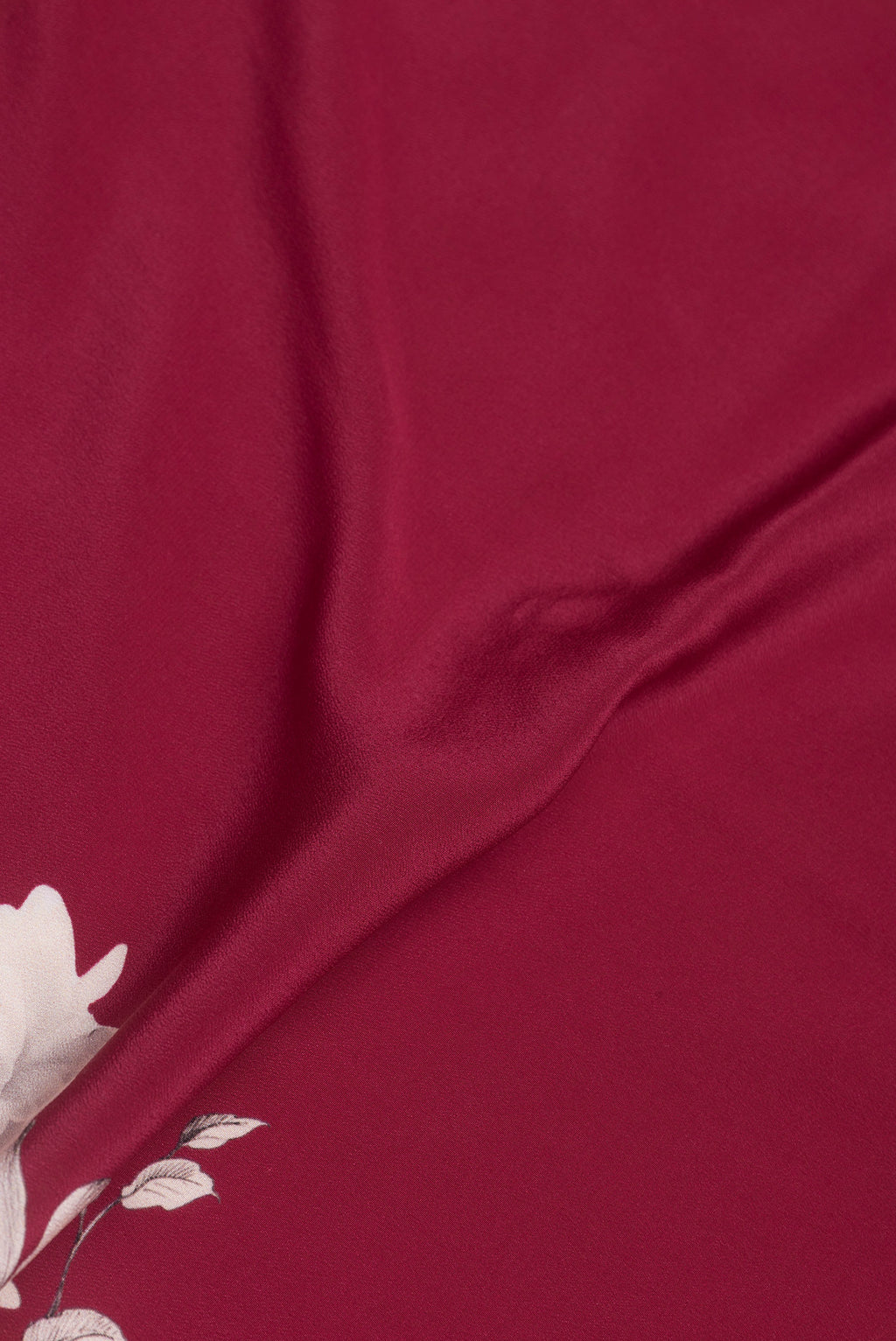 Close up of Dark Pink Dual Tone Crepe Saree with Printed design on the body and Without Border.  displaying folds