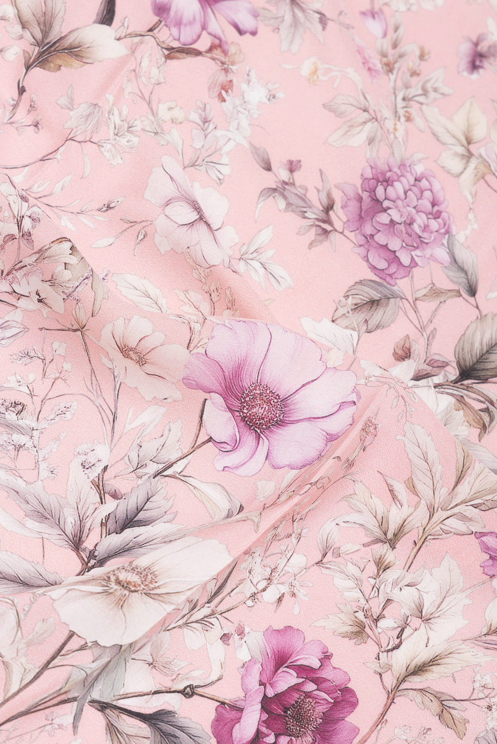 Close up of Rose Gold Crepe Saree with Floral Print on the body and Without Border.  displaying folds