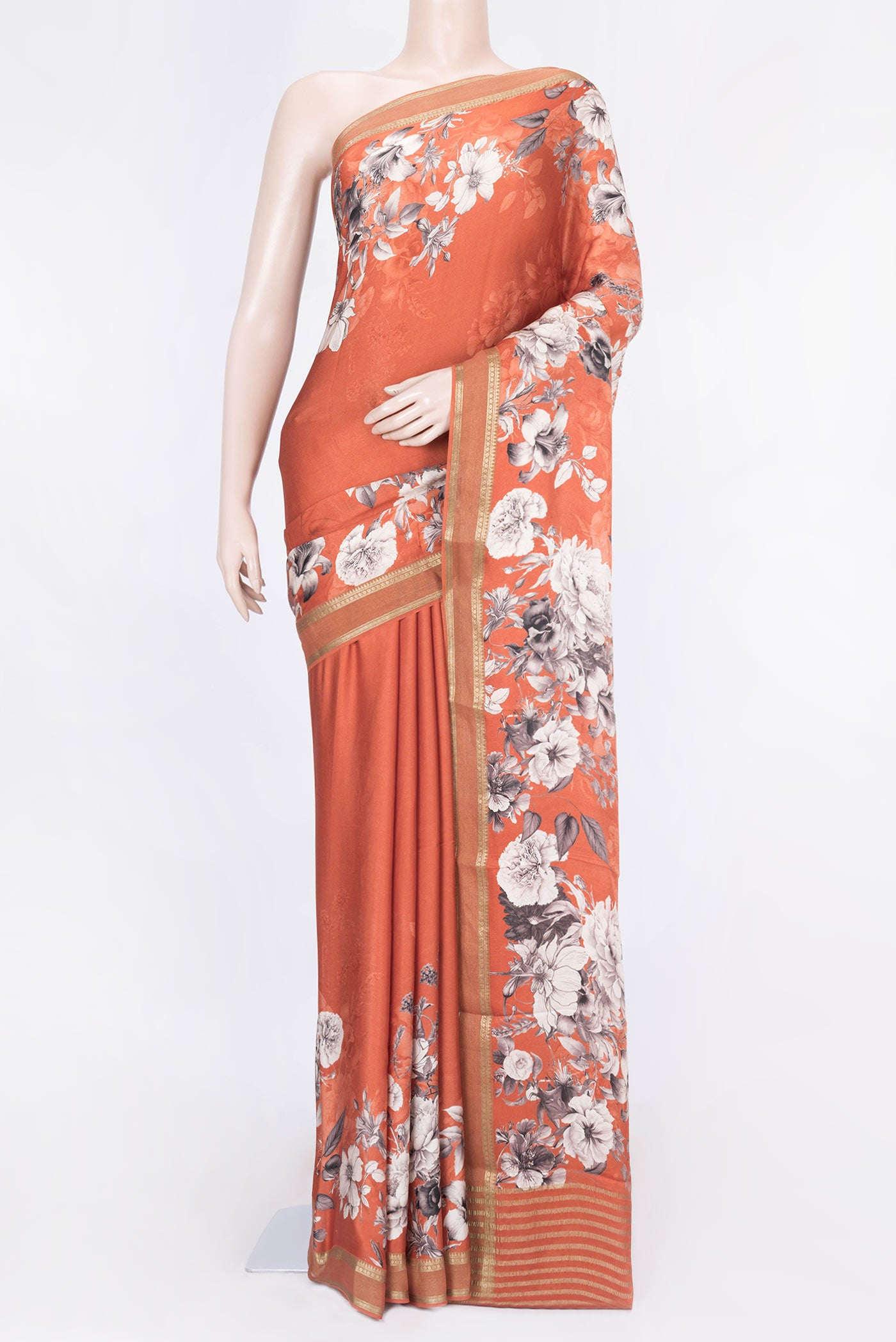 Brick Orange Dual Tone Tussar Silk Saree with Printed design on the body and Zari Border displayed on a mannequin