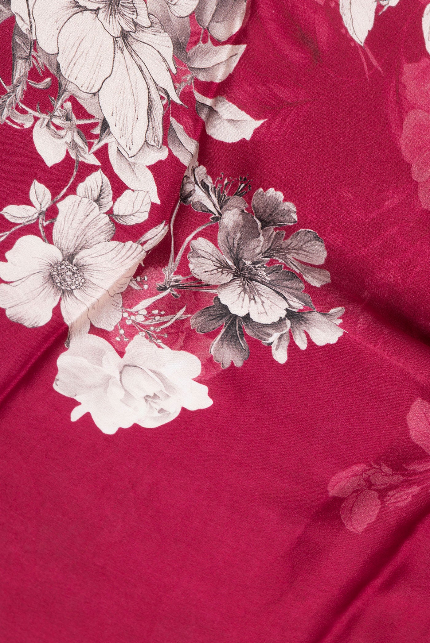 Close up of Dark Pink Dual Tone Mysore Crepe Saree with Printed design on the body and Zari Border.  displaying folds