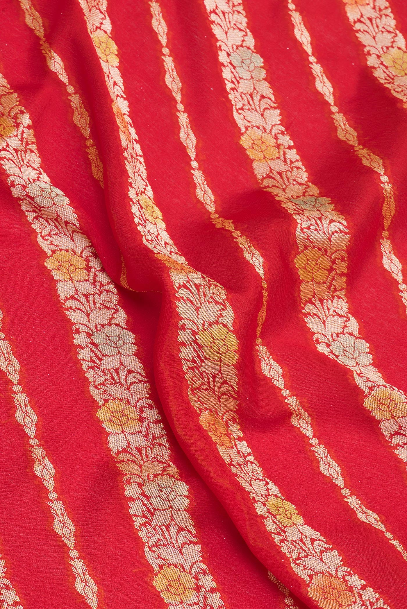 Close up of Red Banarasi Georgette Saree with Zari Brocade on the body and Zari Border.  displaying folds