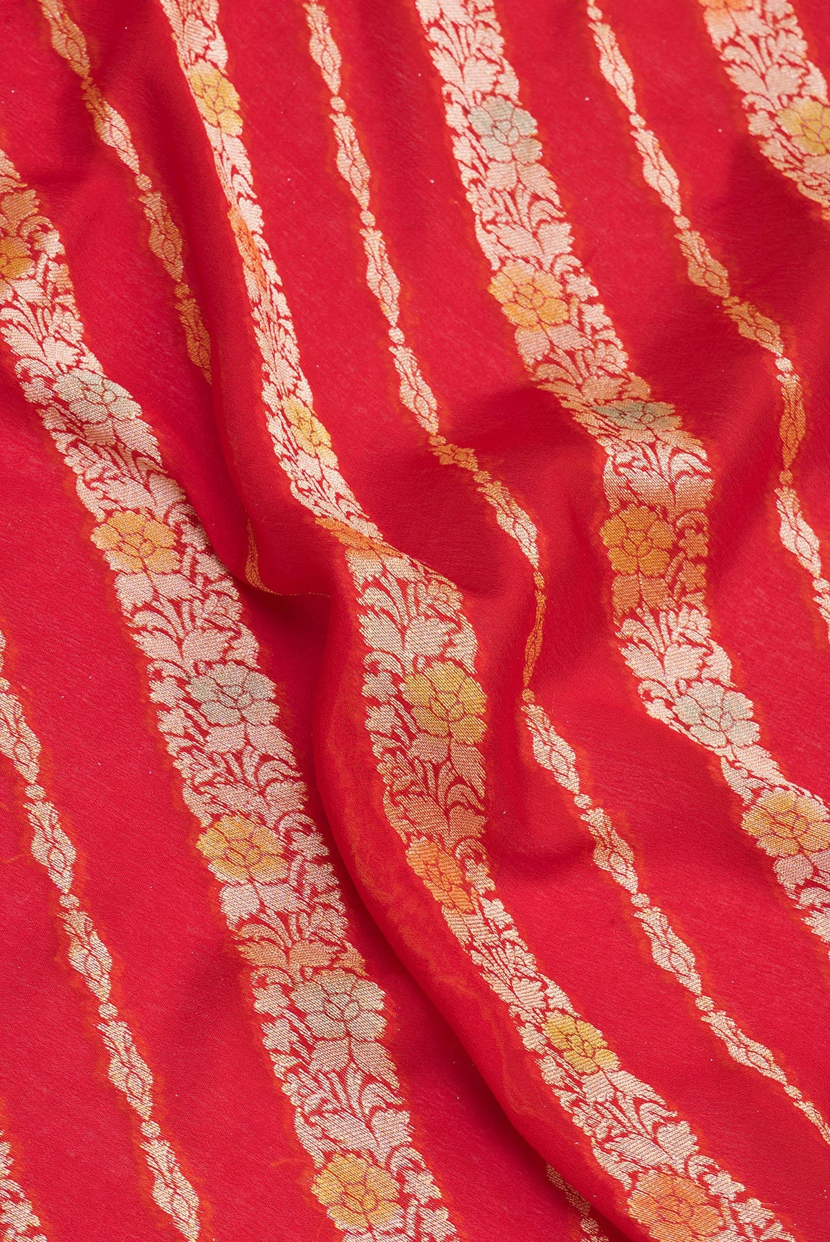 Close up of Red Banarasi Georgette Saree with Zari Brocade on the body and Zari Border.  displaying folds