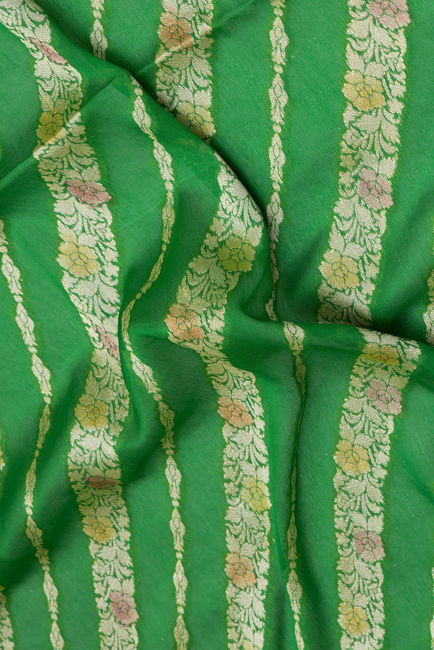 Close up of Green Banarasi Georgette Saree with Zari Brocade on the body and Zari Border.  displaying folds