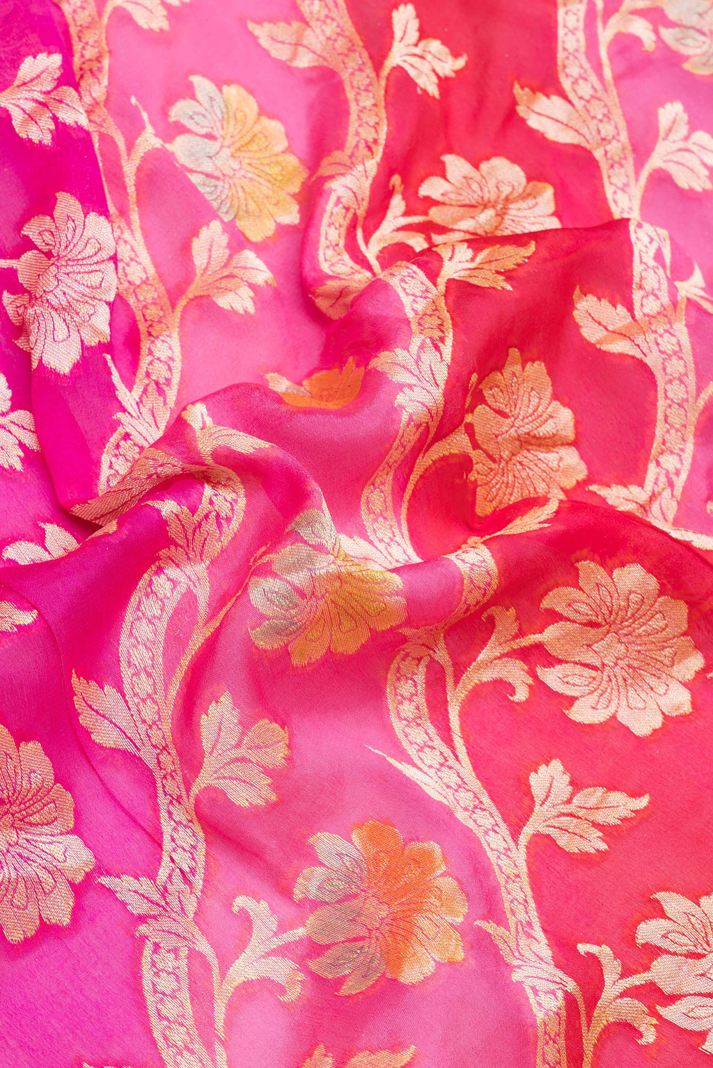 Close up of Pink Banarasi Georgette Saree with Zari And Thread Butta on the body and Zari Border.  displaying folds