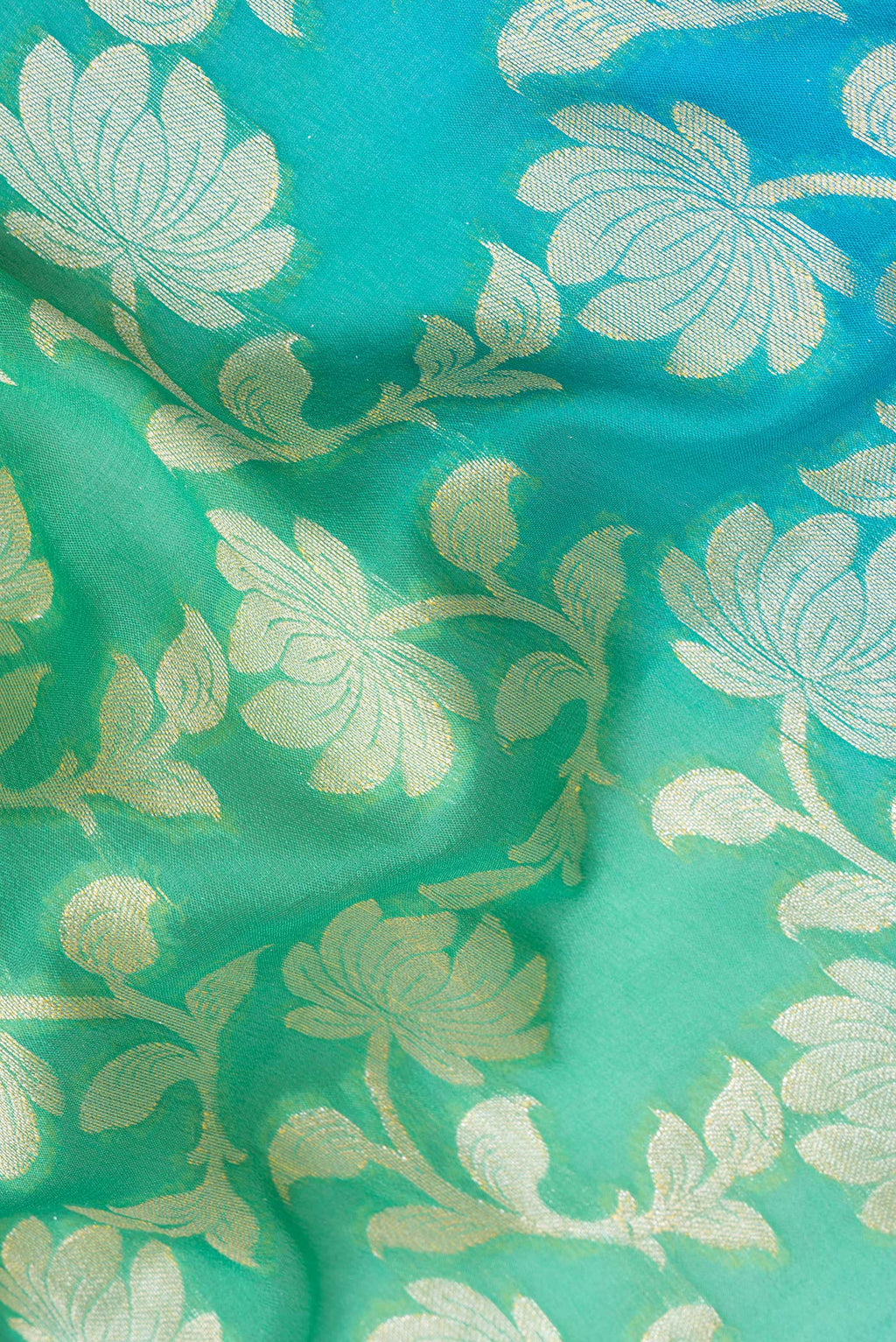 Close up of Sea Green Banarasi Georgette Saree with Zari Brocade on the body and Zari Border.  displaying folds