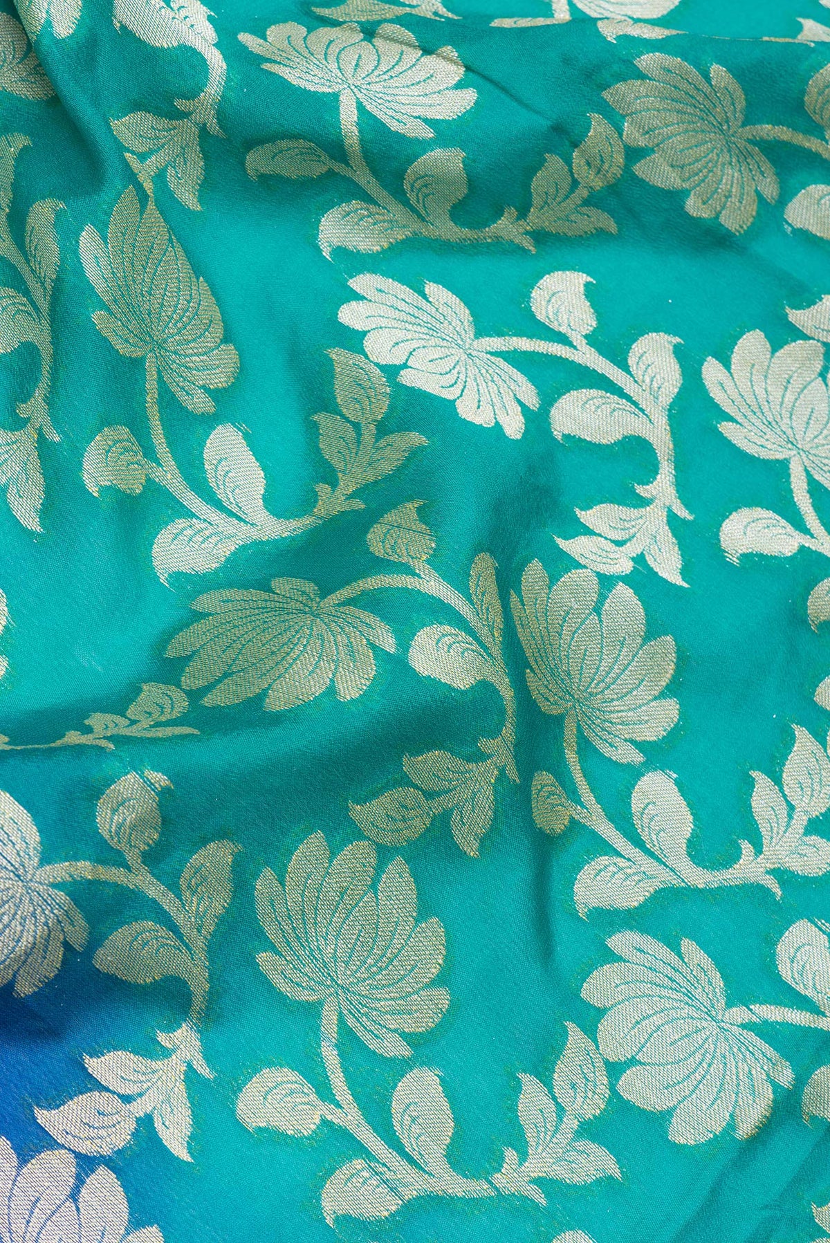 Close up of Sea Green Banarasi Georgette Saree with Zari Brocade on the body and Zari Border.  displaying folds