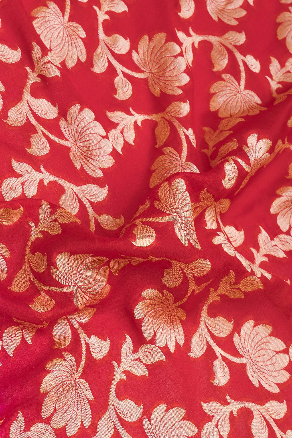 Close up of Red Banarasi Georgette Saree with Zari Brocade on the body and Zari Border.  displaying folds