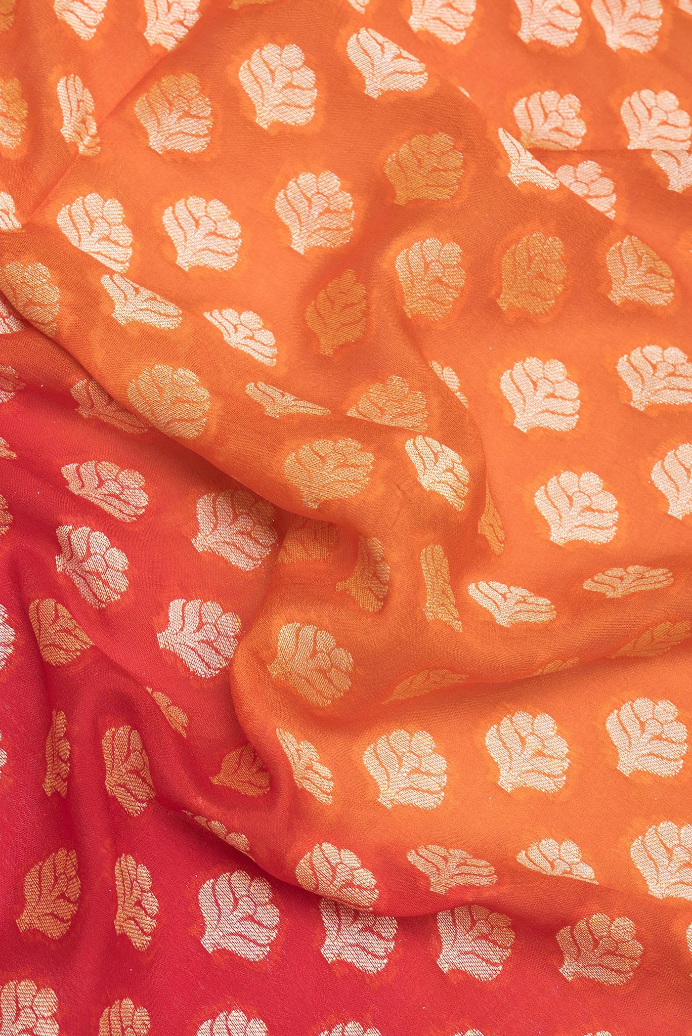 Close up of Orange Banarasi Georgette Saree with Zari Brocade on the body and Zari Border.  displaying folds