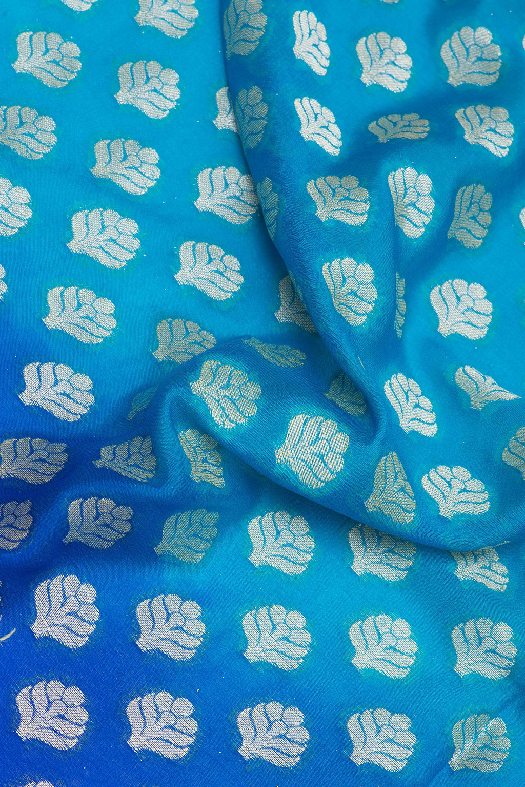 Close up of Sky Blue Banarasi Georgette Saree with Zari Brocade on the body and Zari Border.  displaying folds
