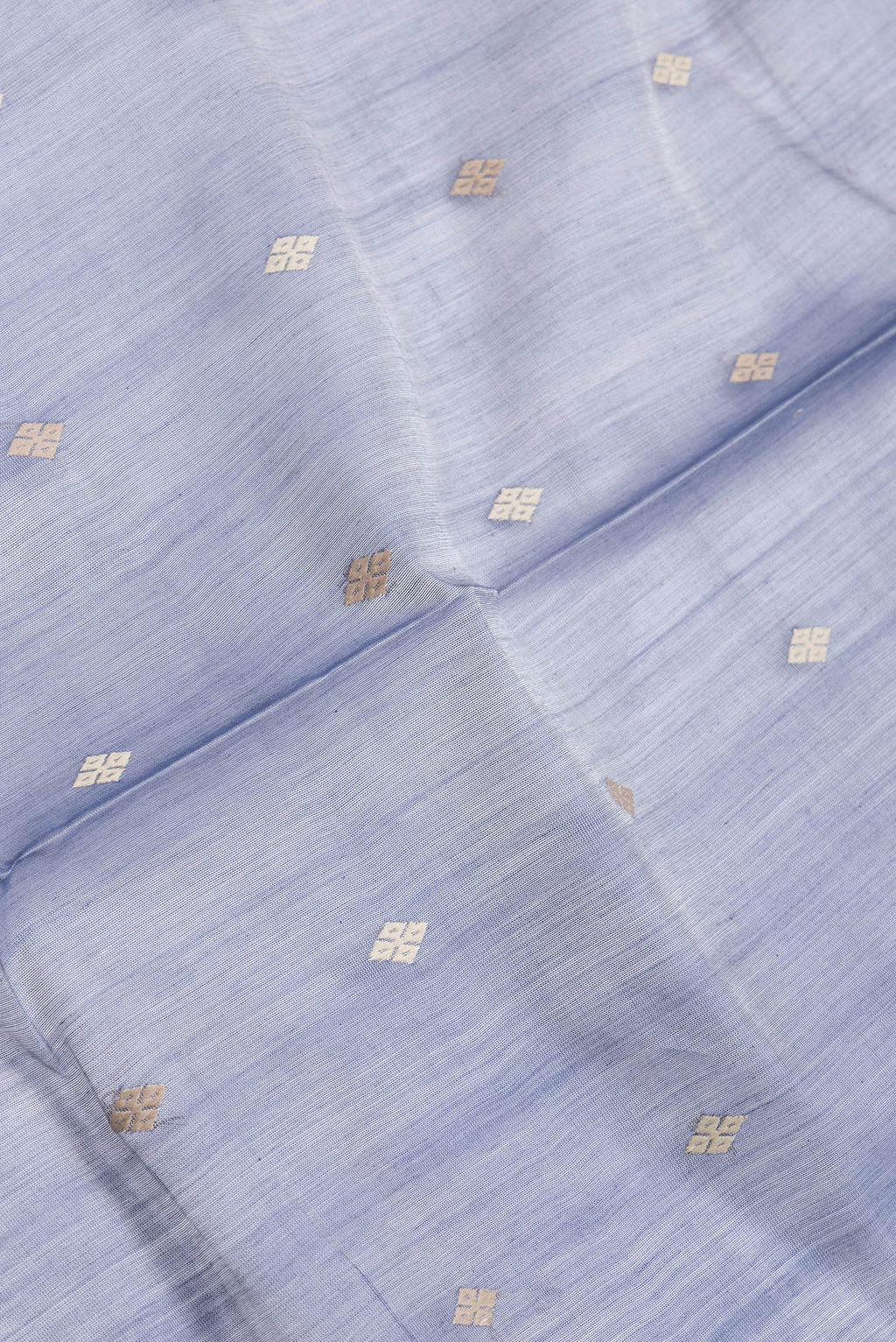 Close up of Grey Dual Tone Tussar Silk Saree with Thread Butta on the body and Zari And Thread Border.  displaying folds