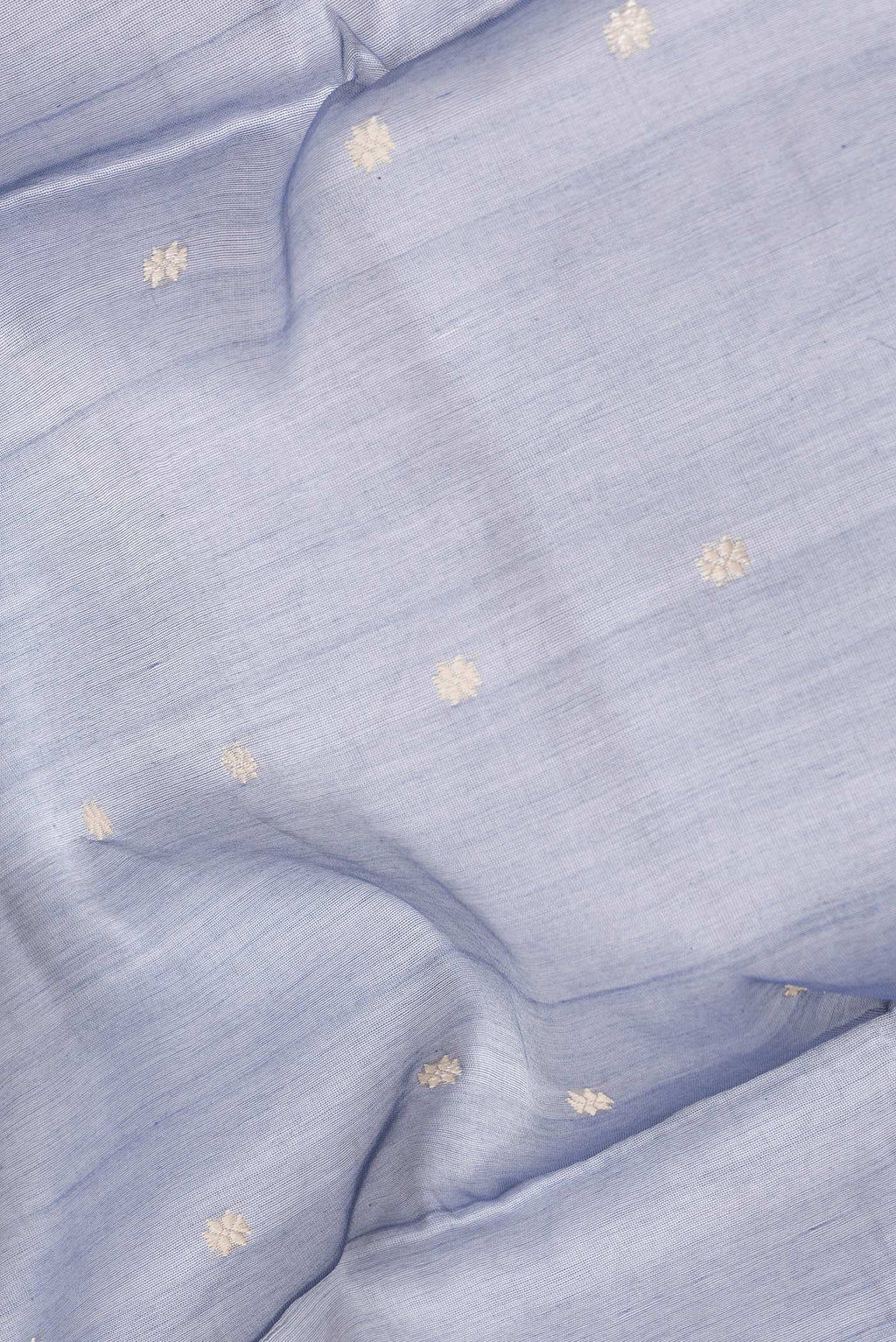 Close up of Grey Dual Tone Tussar Silk Saree with Thread Butta on the body and Without Border.  displaying folds