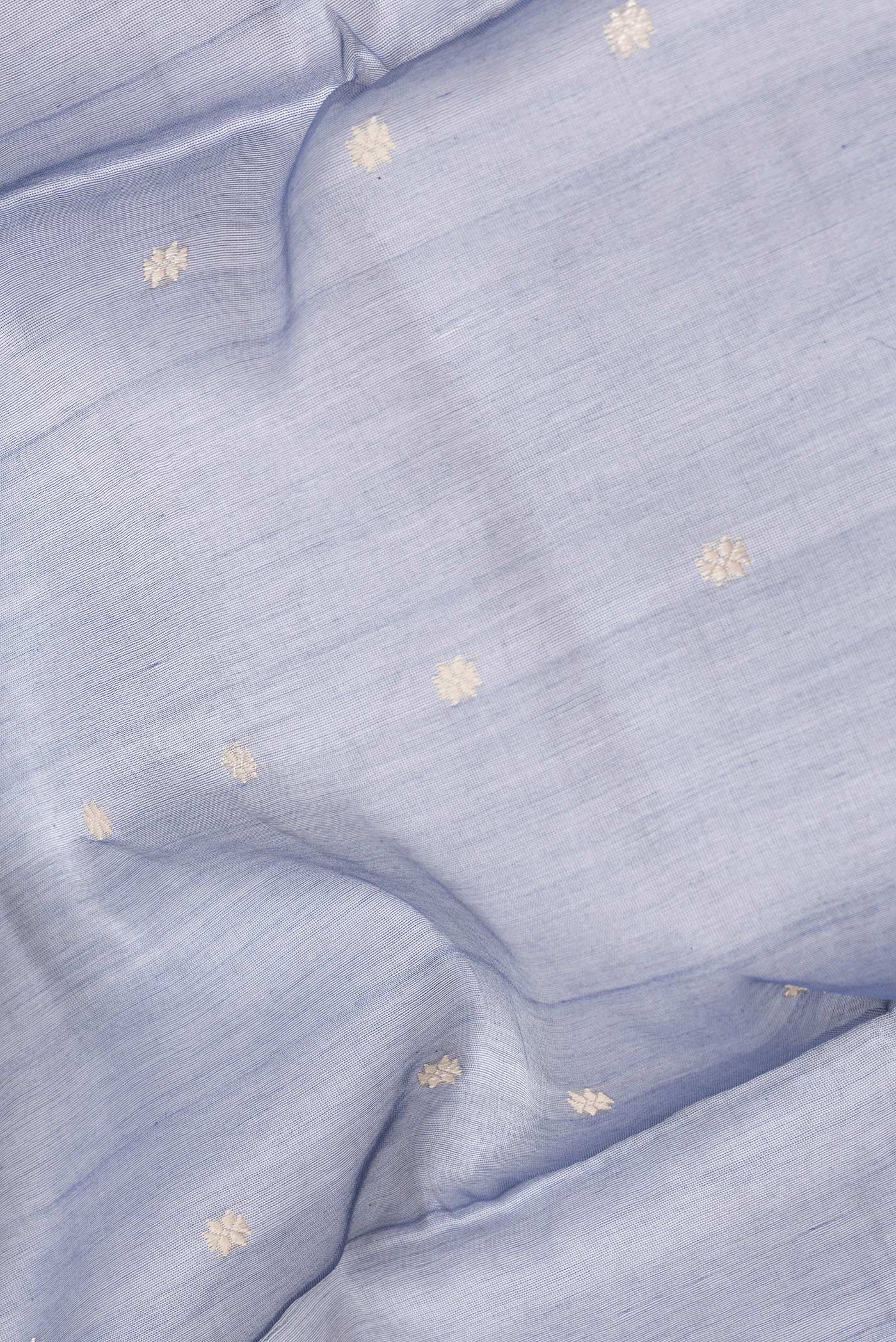 Close up of Grey Dual Tone Tussar Silk Saree with Thread Butta on the body and Without Border.  displaying folds