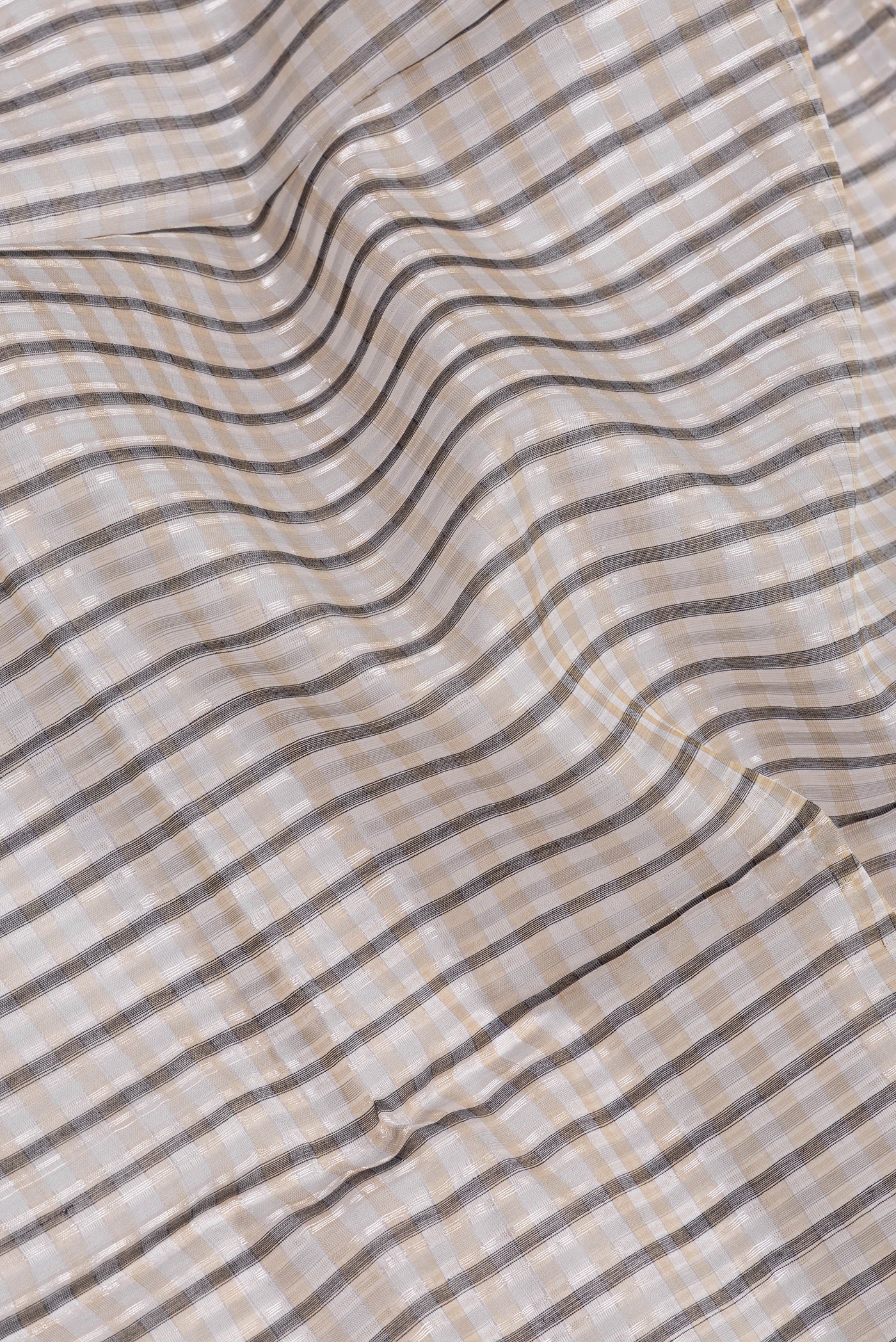 Close up of Grey Tussar Silk Saree with Stripes on the body and Without Border.  displaying folds