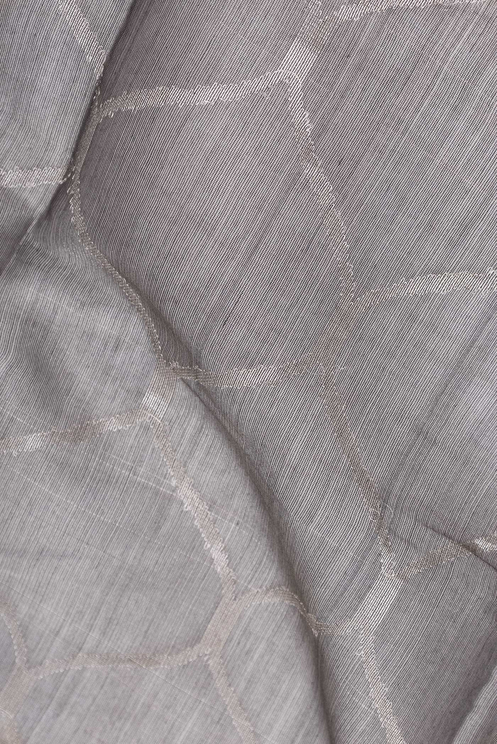 Close up of Grey Dual Tone Organza Silk Saree with Zari Brocade on the body and Zari Border.  displaying folds