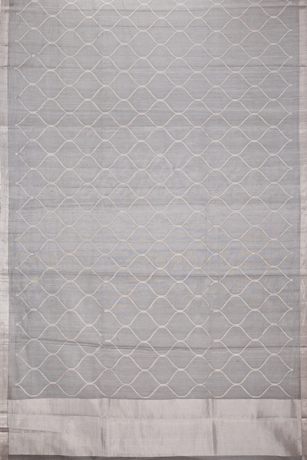 Flat view of Grey Dual Tone Organza Silk Saree with Zari Brocade on the body and Zari Border. 
