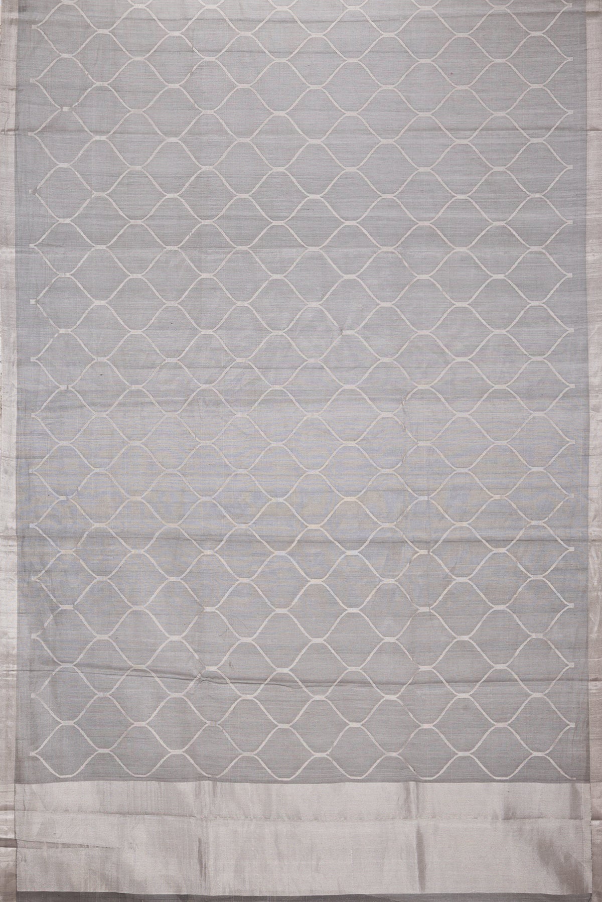 Flat view of Grey Dual Tone Organza Silk Saree with Zari Brocade on the body and Zari Border. 