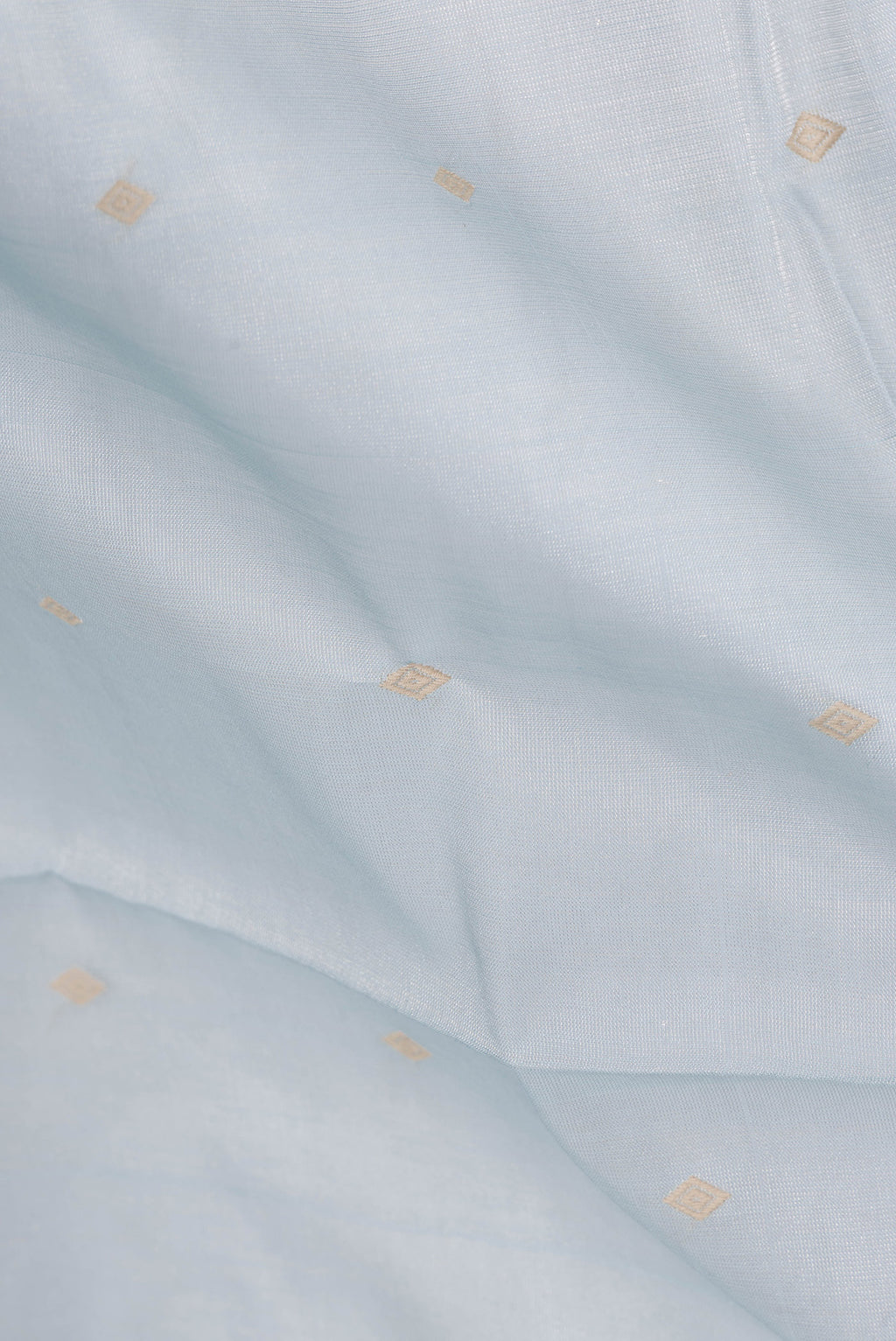 Close up of Light Blue Dual Tone Chanderi Tissue Silk Saree with Thread Butta on the body and Plain Border.  displaying folds