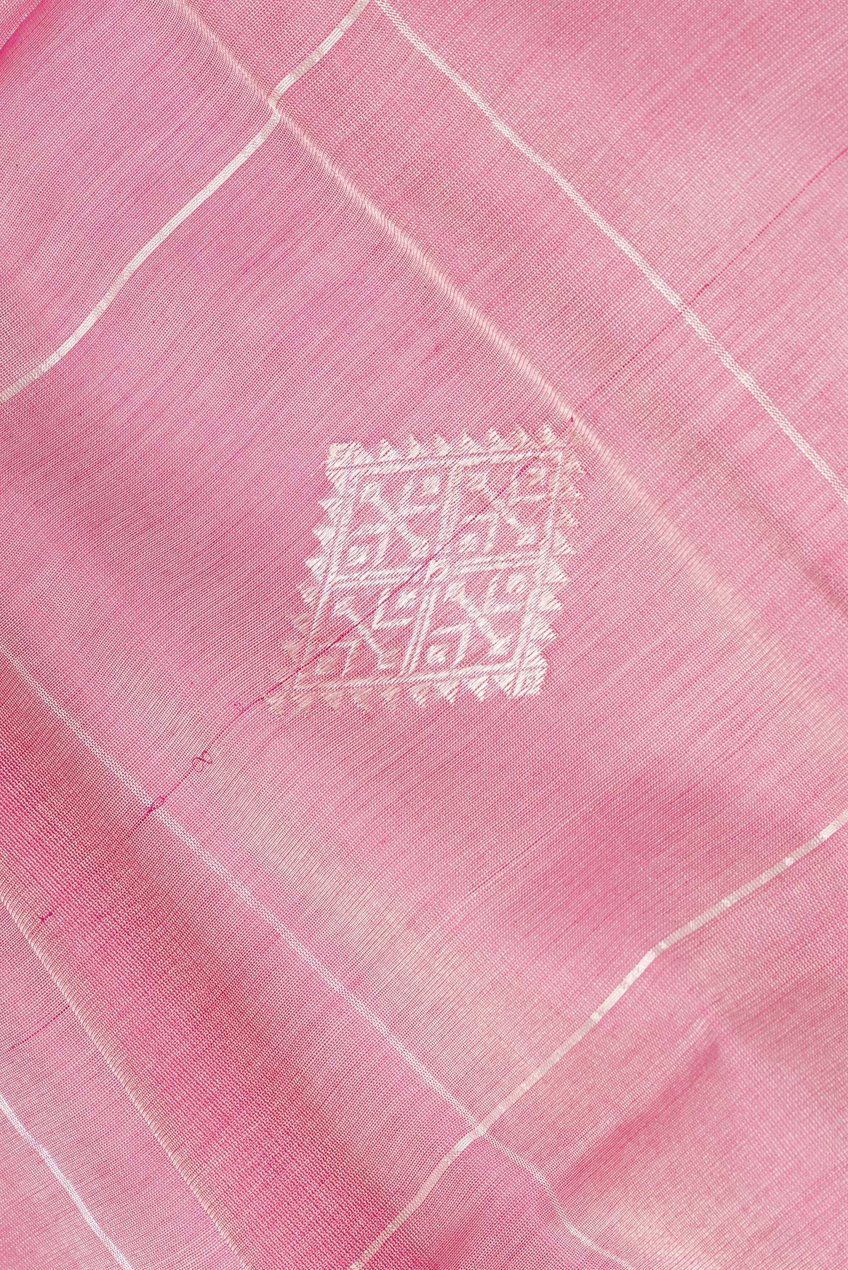 Close up of Pink Tussar Saree with Checked design on the body and Zari Border.  displaying folds