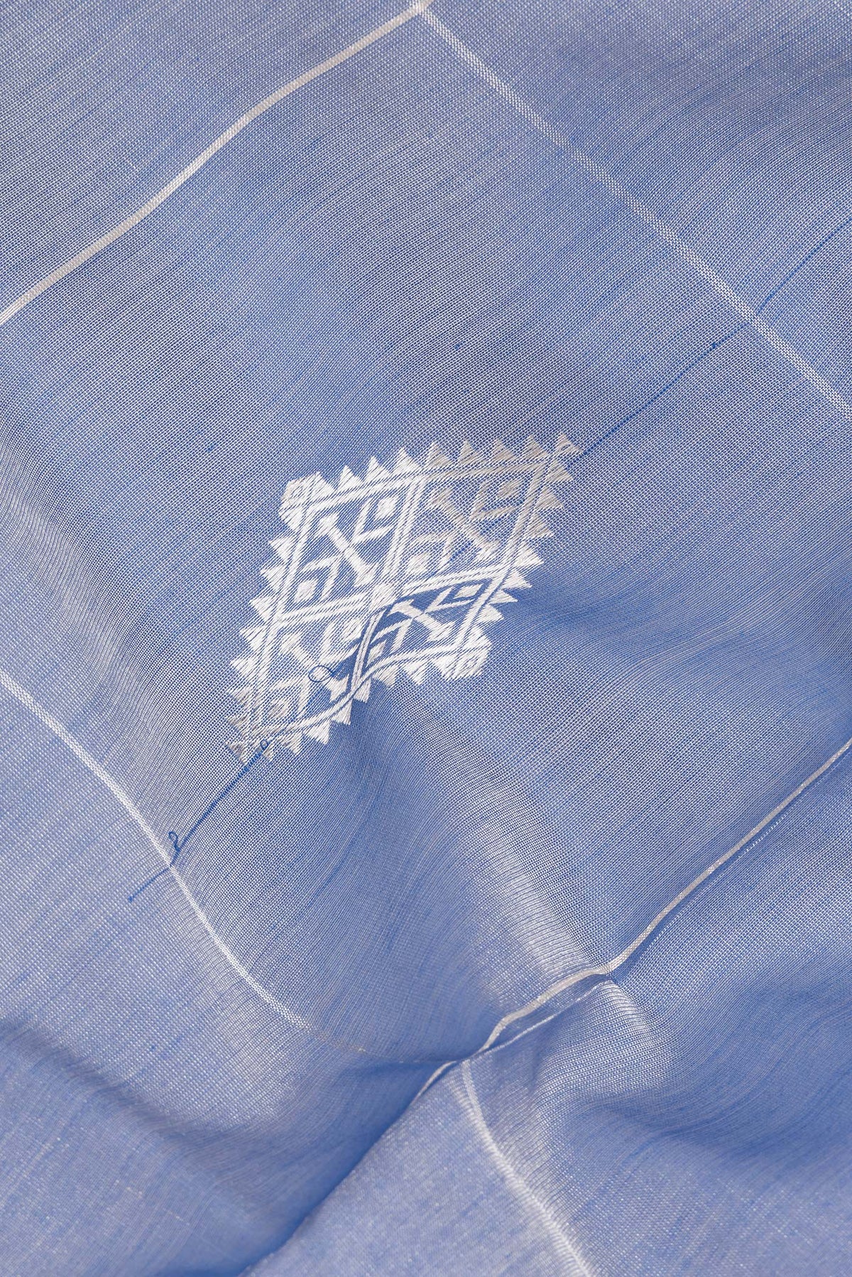 Close up of Maya Blue Tussar Saree with Checked design on the body and Zari Border.  displaying folds