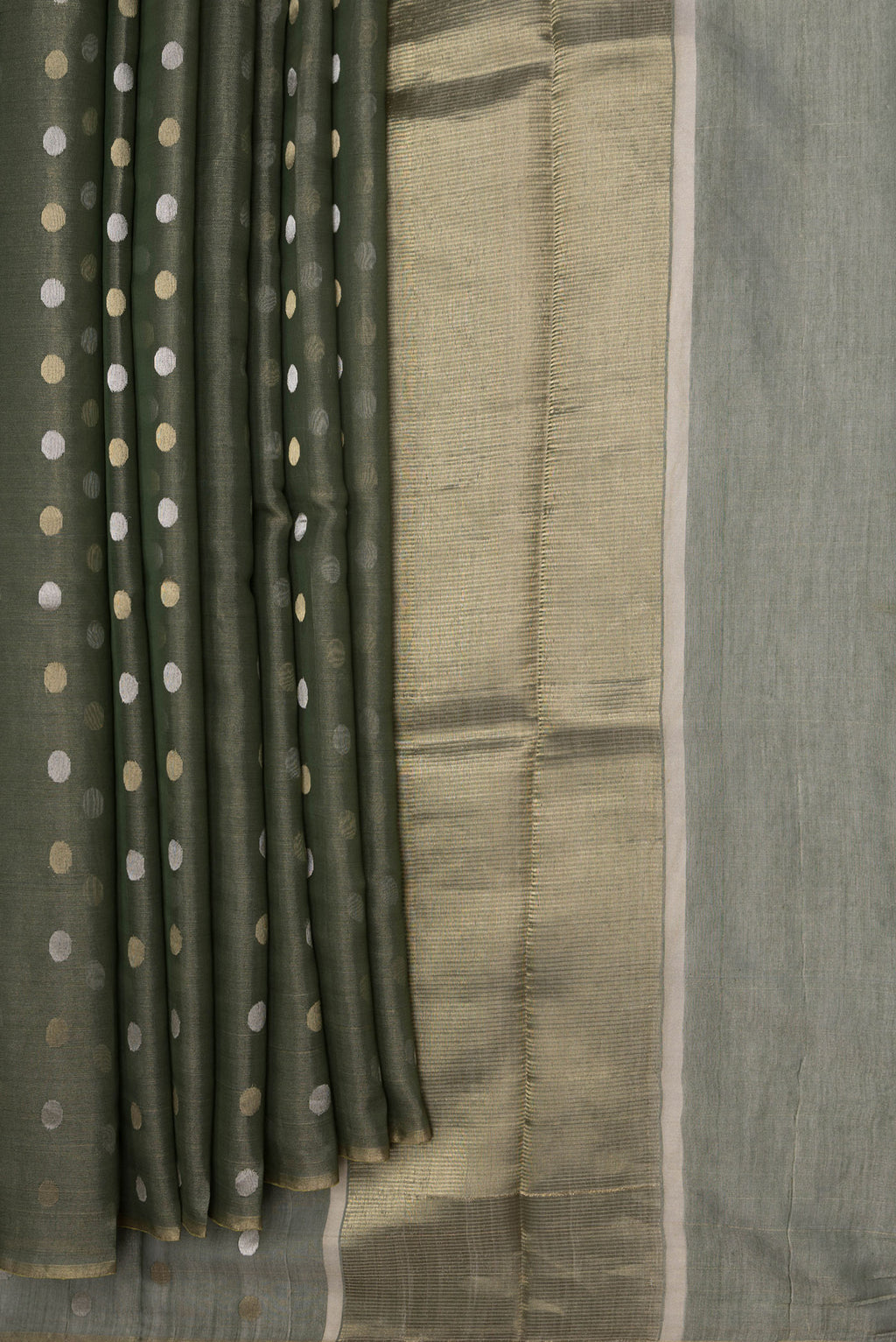Pleats and pallu of Bottle Green Dual Tone Chanderi Silk Saree with Zari Butta on the body and Thin Zari Line. 
