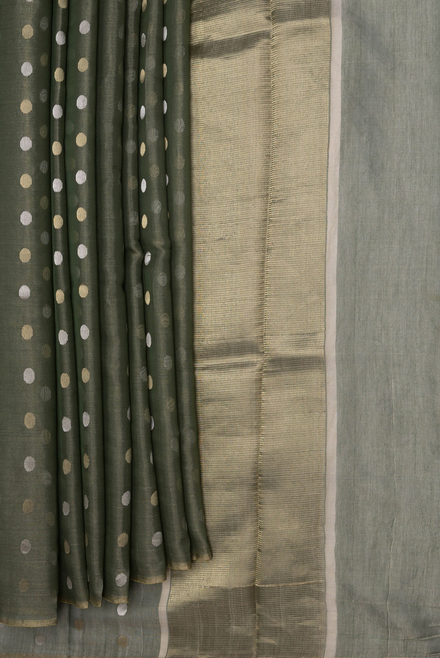 Pleats and pallu of Bottle Green Dual Tone Chanderi Silk Saree with Zari Butta on the body and Thin Zari Line. 