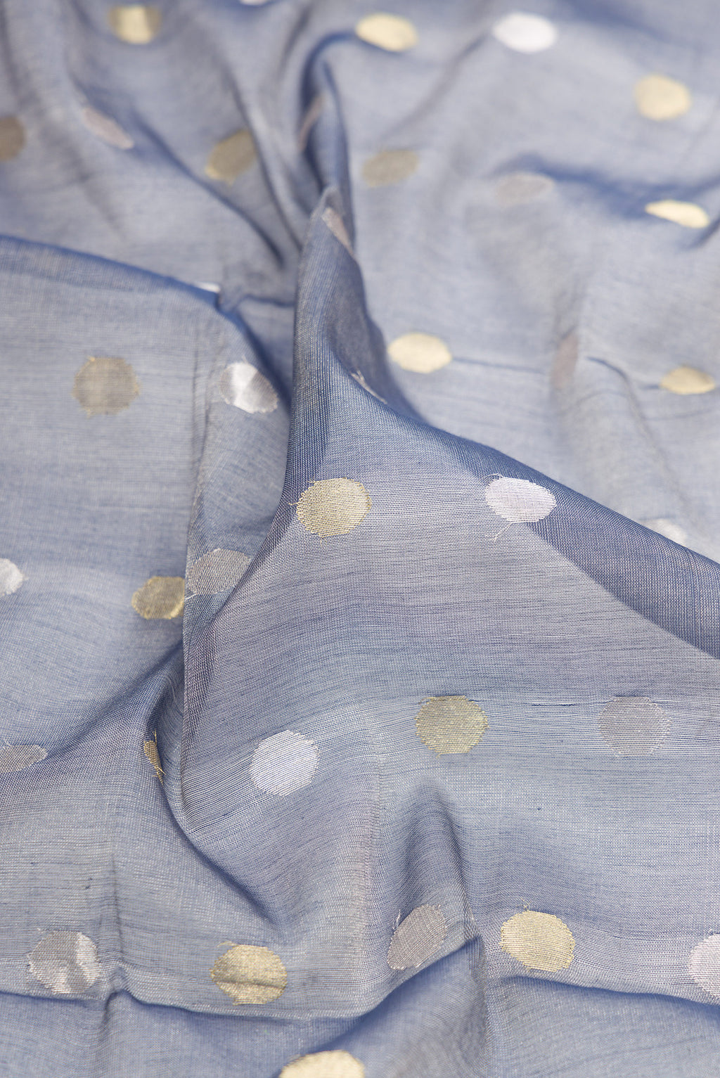 Close up of Grey Dual Tone Chanderi Tissue Silk Saree with Zari Butta on the body and Zari Border.  displaying folds