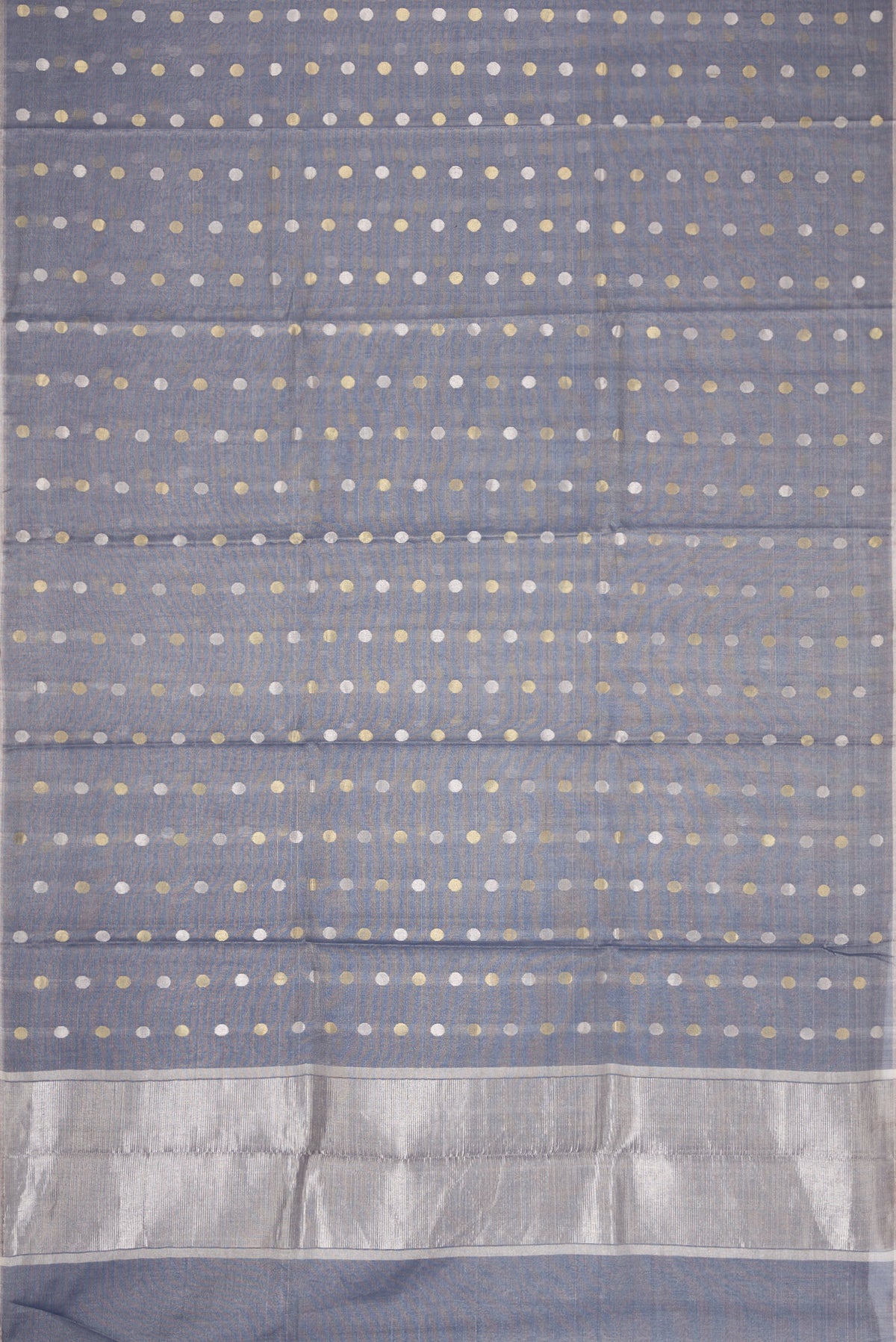 Flat view of Grey Dual Tone Chanderi Tissue Silk Saree with Zari Butta on the body and Zari Border. 