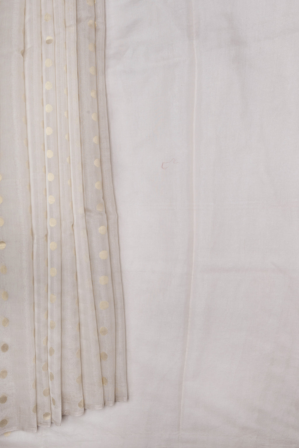 Pleats and pallu of Beige Dual Tone Chanderi Silk Saree with Zari Butta on the body and Thin Zari Line. 