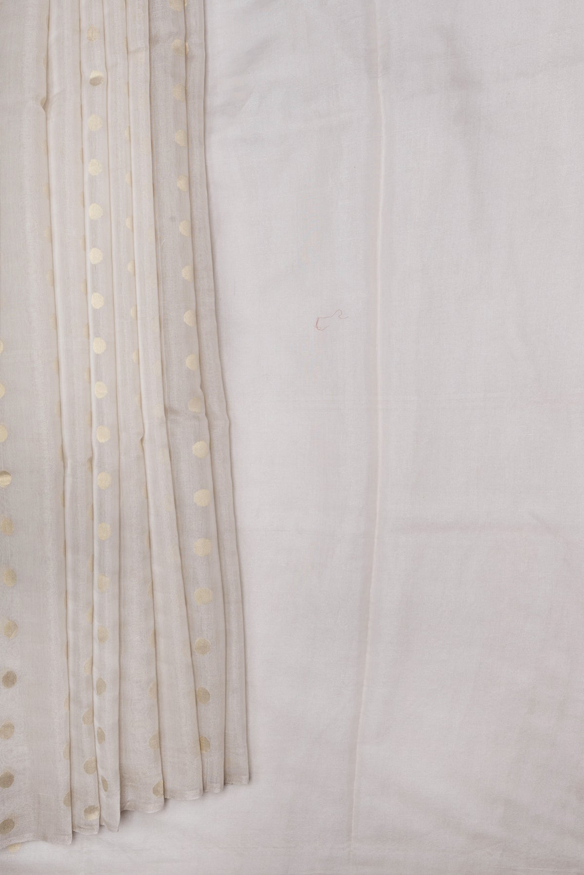 Pleats and pallu of Beige Dual Tone Chanderi Silk Saree with Zari Butta on the body and Thin Zari Line. 