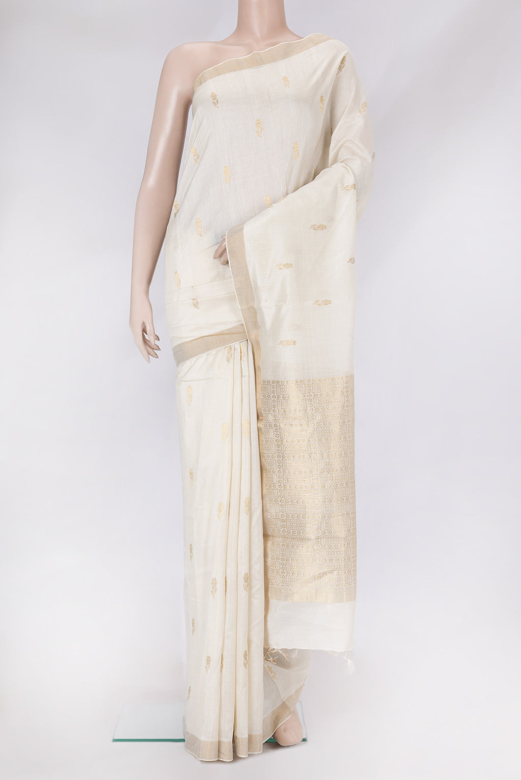 White Tussar Silk Saree with Zari Butta on the body and Zari Border.  displayed on a mannequin