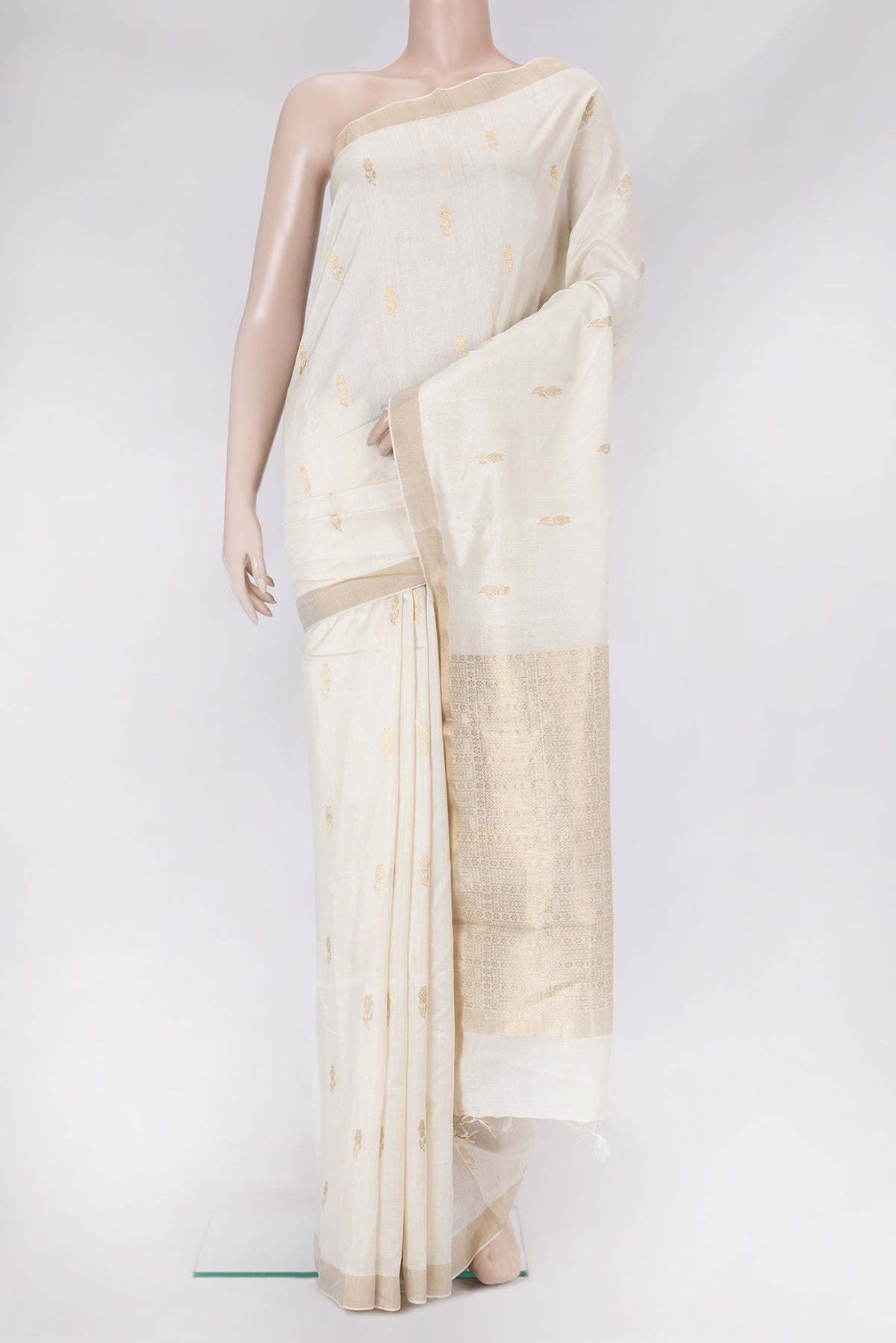 White Tussar Silk Saree with Zari Butta on the body and Zari Border.  displayed on a mannequin