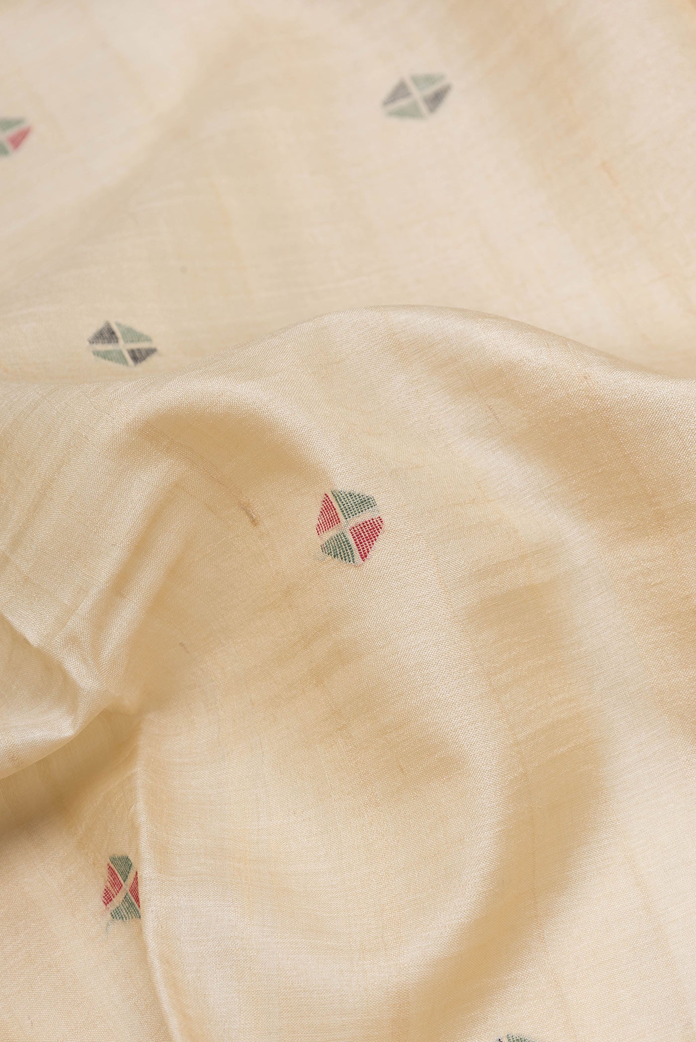 Close up of Beige Dual Tone Tussar Silk Saree with Thread Butta on the body and Thread Border.  displaying folds
