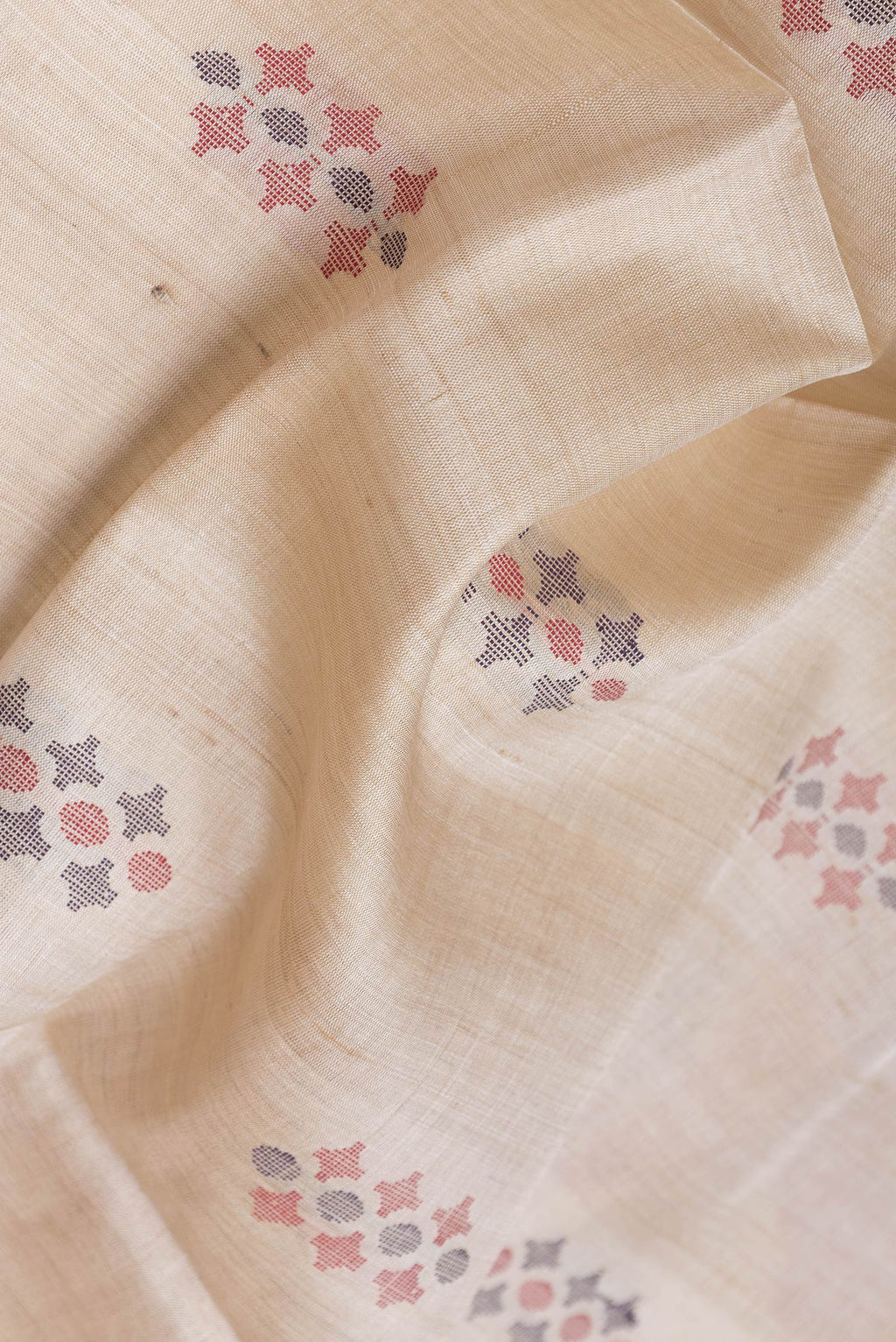 Close up of Beige Dual Tone Tussar Silk Saree with Thread Butta on the body and Thread Border.  displaying folds