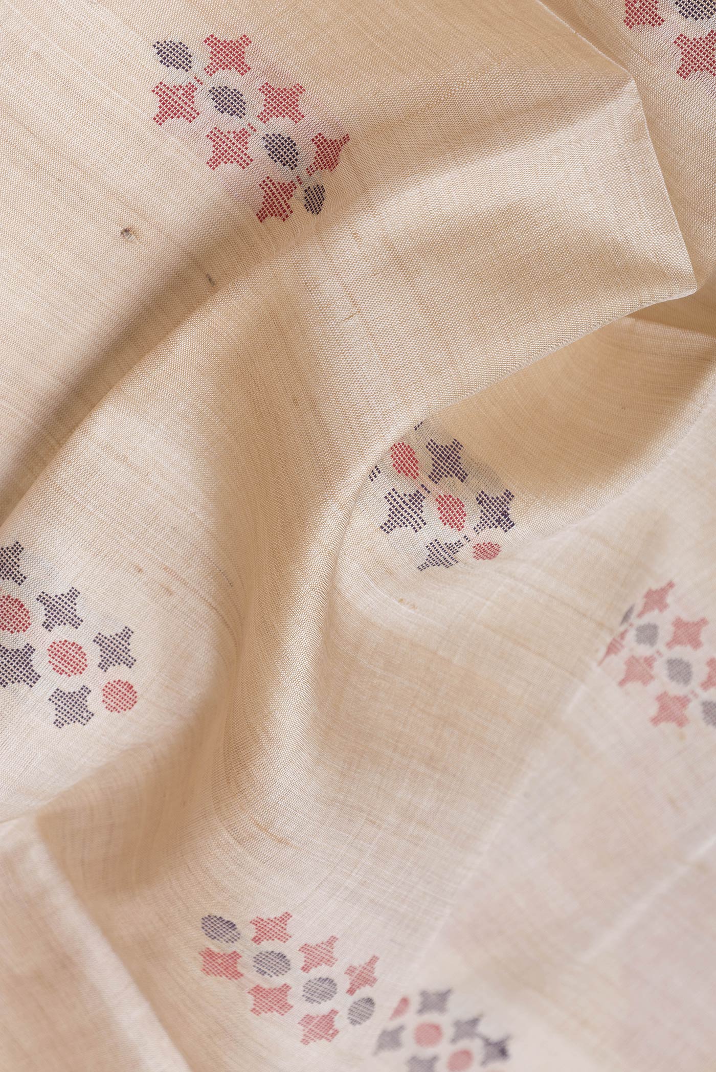 Close up of Beige Dual Tone Tussar Silk Saree with Thread Butta on the body and Thread Border.  displaying folds