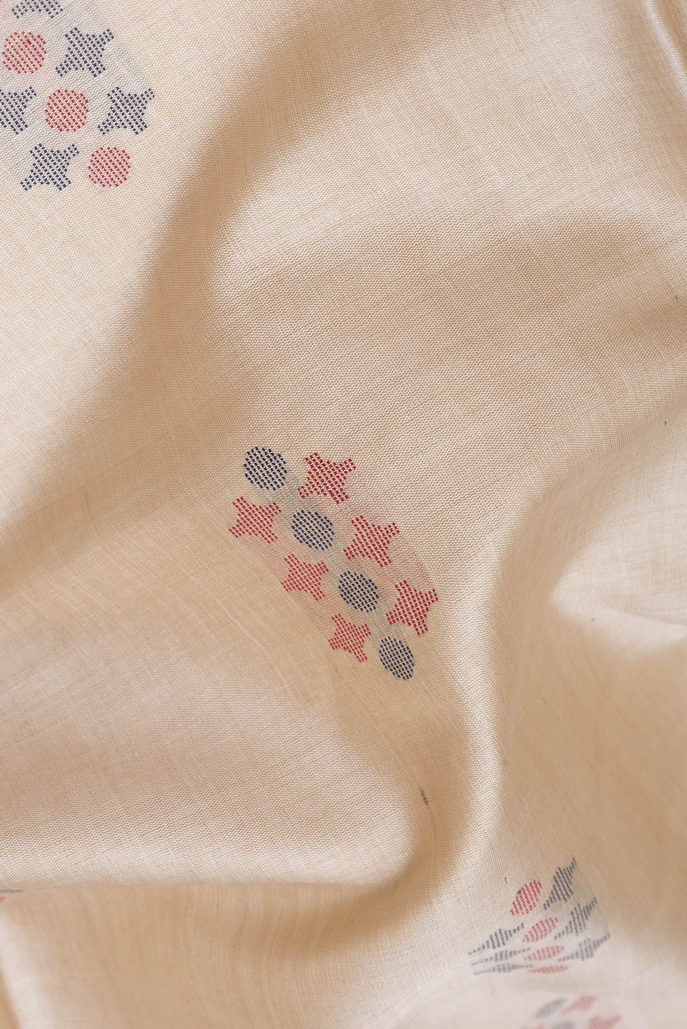 Close up of Beige Dual Tone Tussar Silk Saree with Thread Butta on the body and Thread Border.  displaying folds
