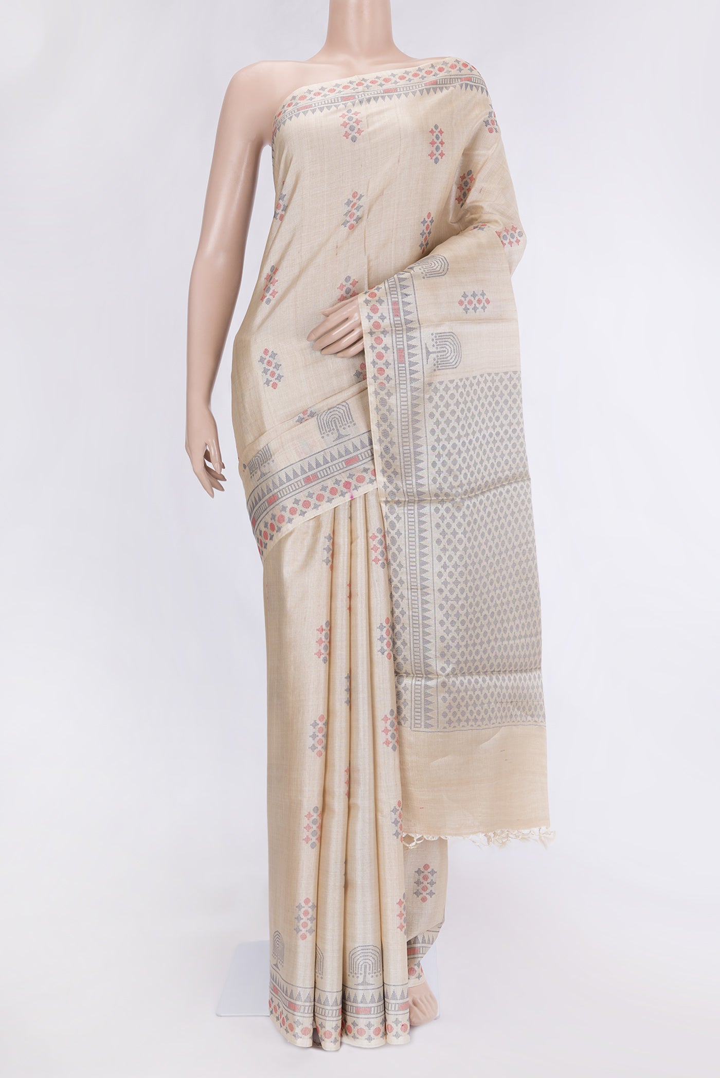 Beige Dual Tone Tussar Silk Saree with Thread Butta on the body and Thread Border.  displayed on a mannequin