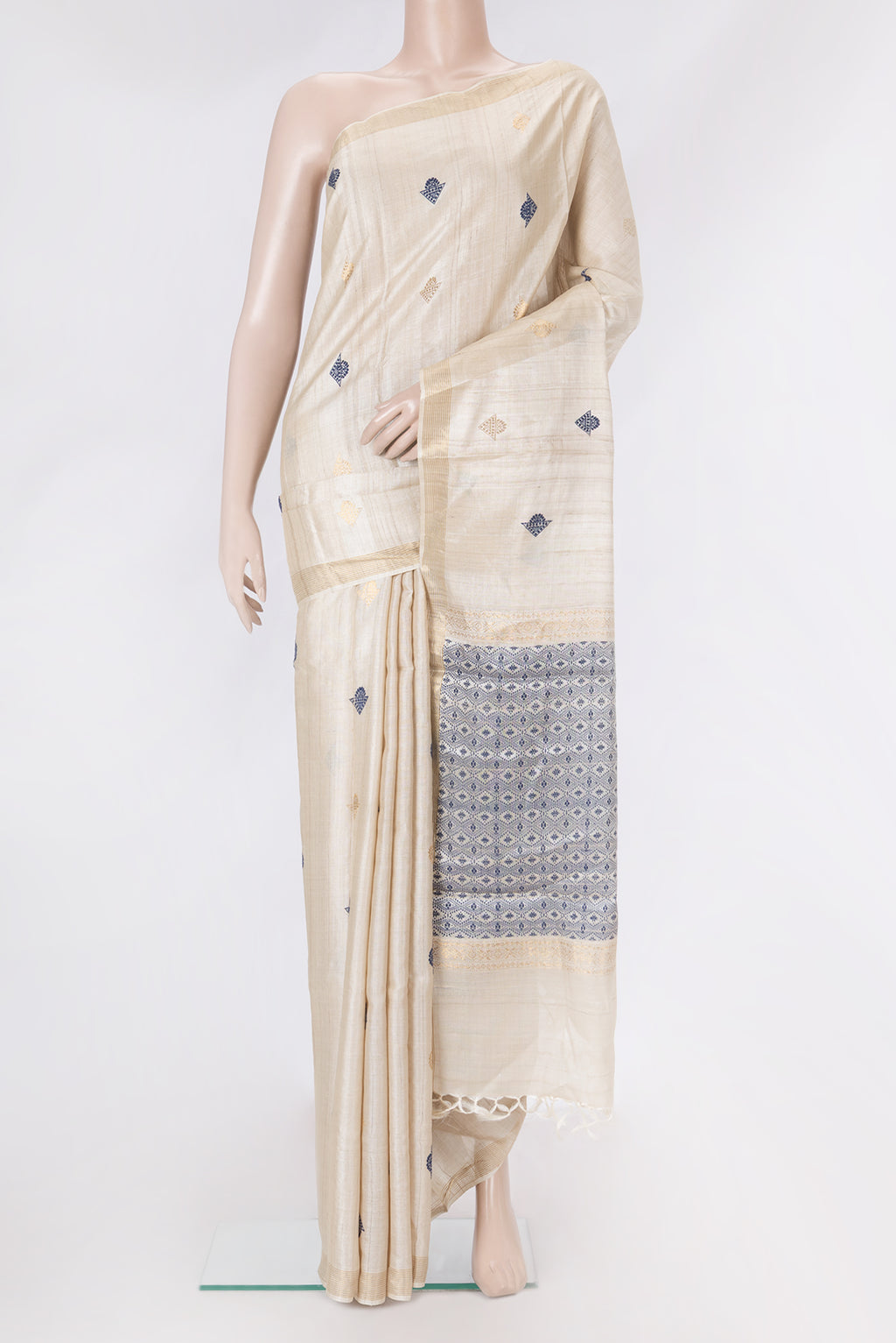Beige Dual Tone Tussar Silk Saree with Zari And Thread Butta on the body and Zari Border.  displayed on a mannequin