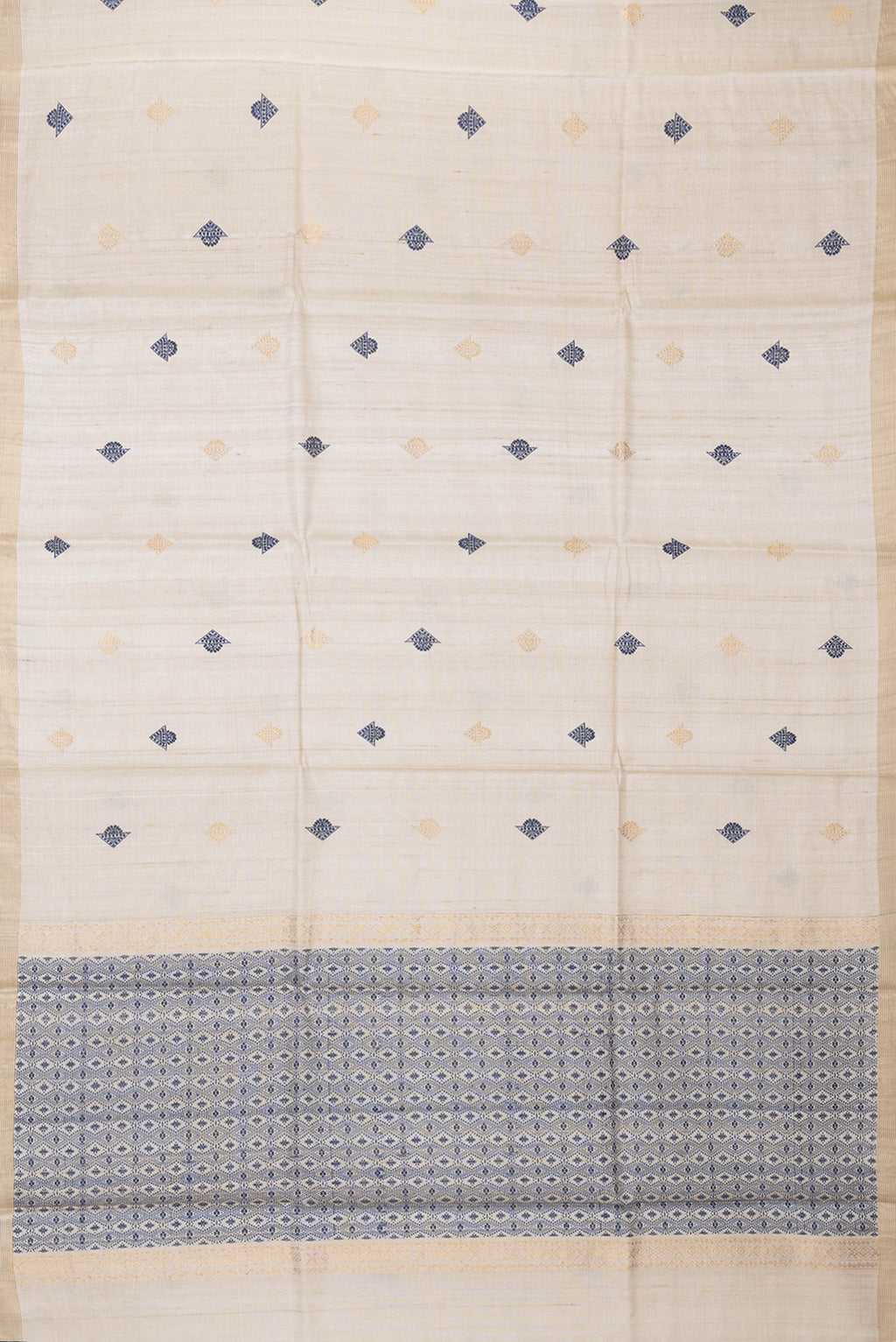 Flat view of Beige Dual Tone Tussar Silk Saree with Zari And Thread Butta on the body and Zari Border. 