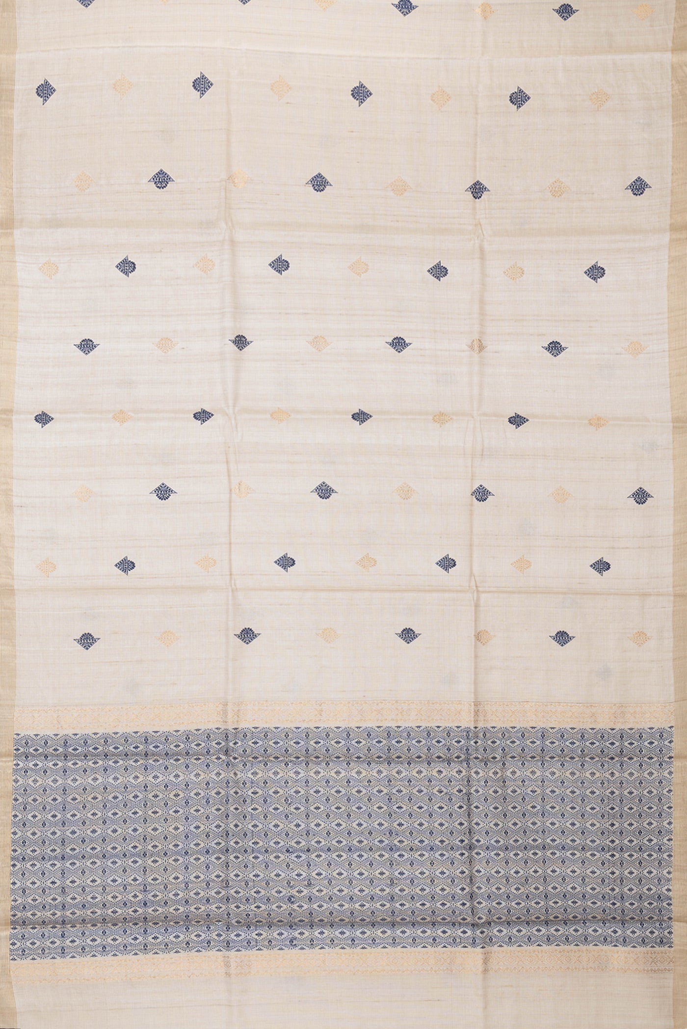 Flat view of Beige Dual Tone Tussar Silk Saree with Zari And Thread Butta on the body and Zari Border. 
