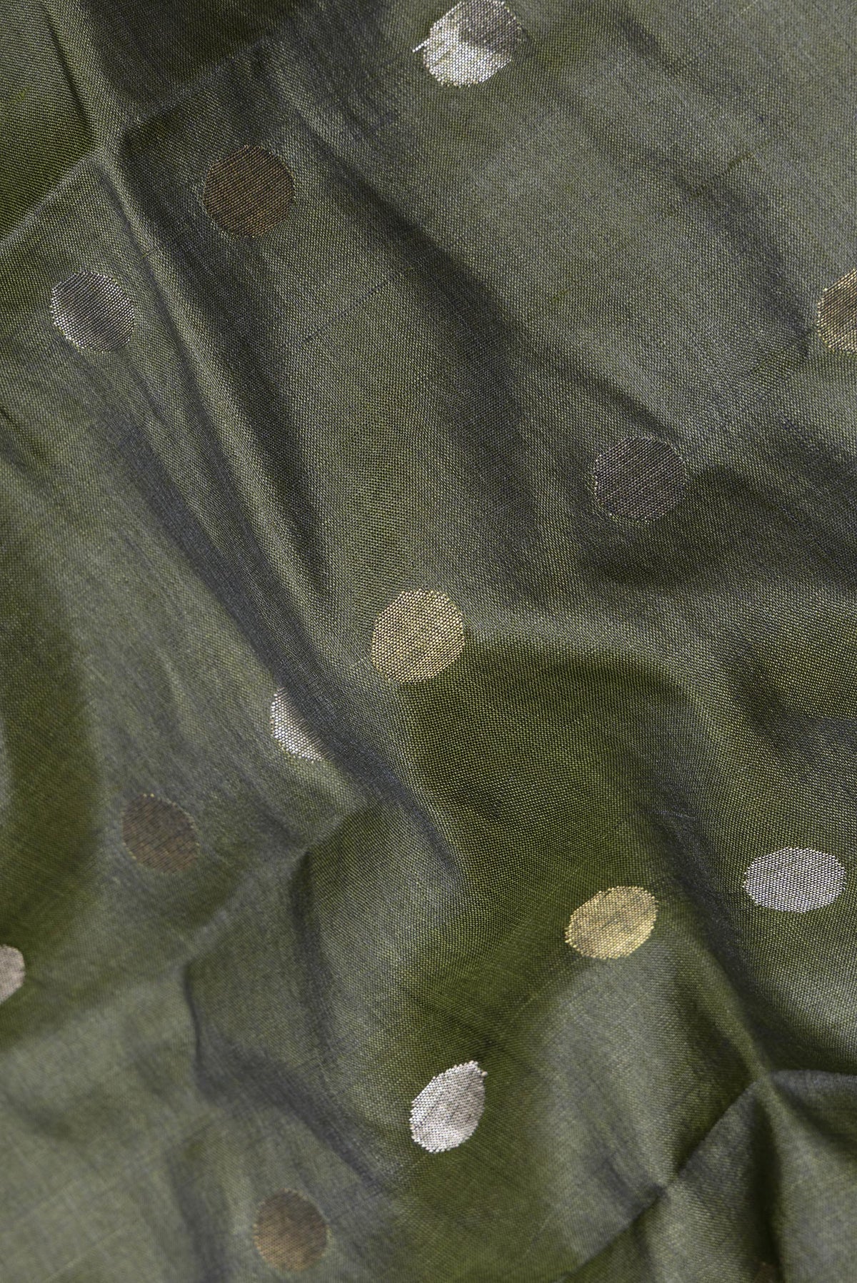 Close up of Mehandi Green Dual Tone Tussar Saree with Zari Butta on the body and Zari Border.  displaying folds