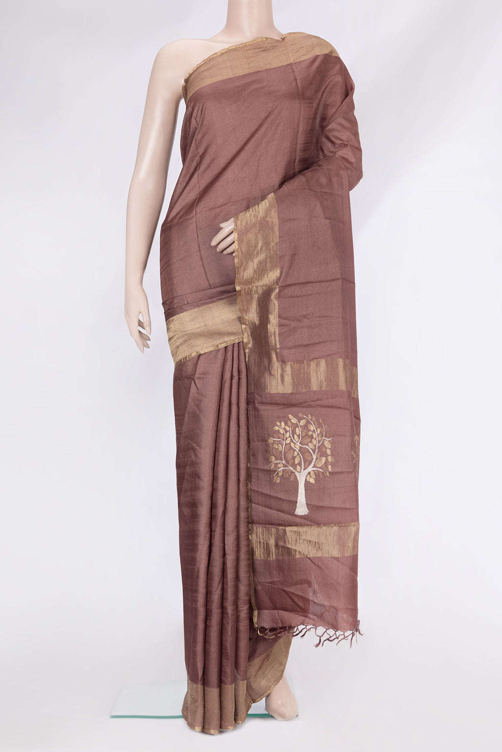 Brown Tussar Silk Saree with Plain Body and Zari Border.  displayed on a mannequin