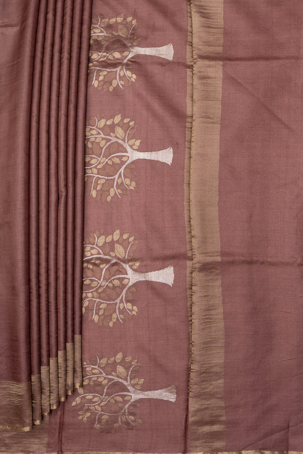 Pleats and pallu of Brown Tussar Silk Saree with Plain Body and Zari Border. 
