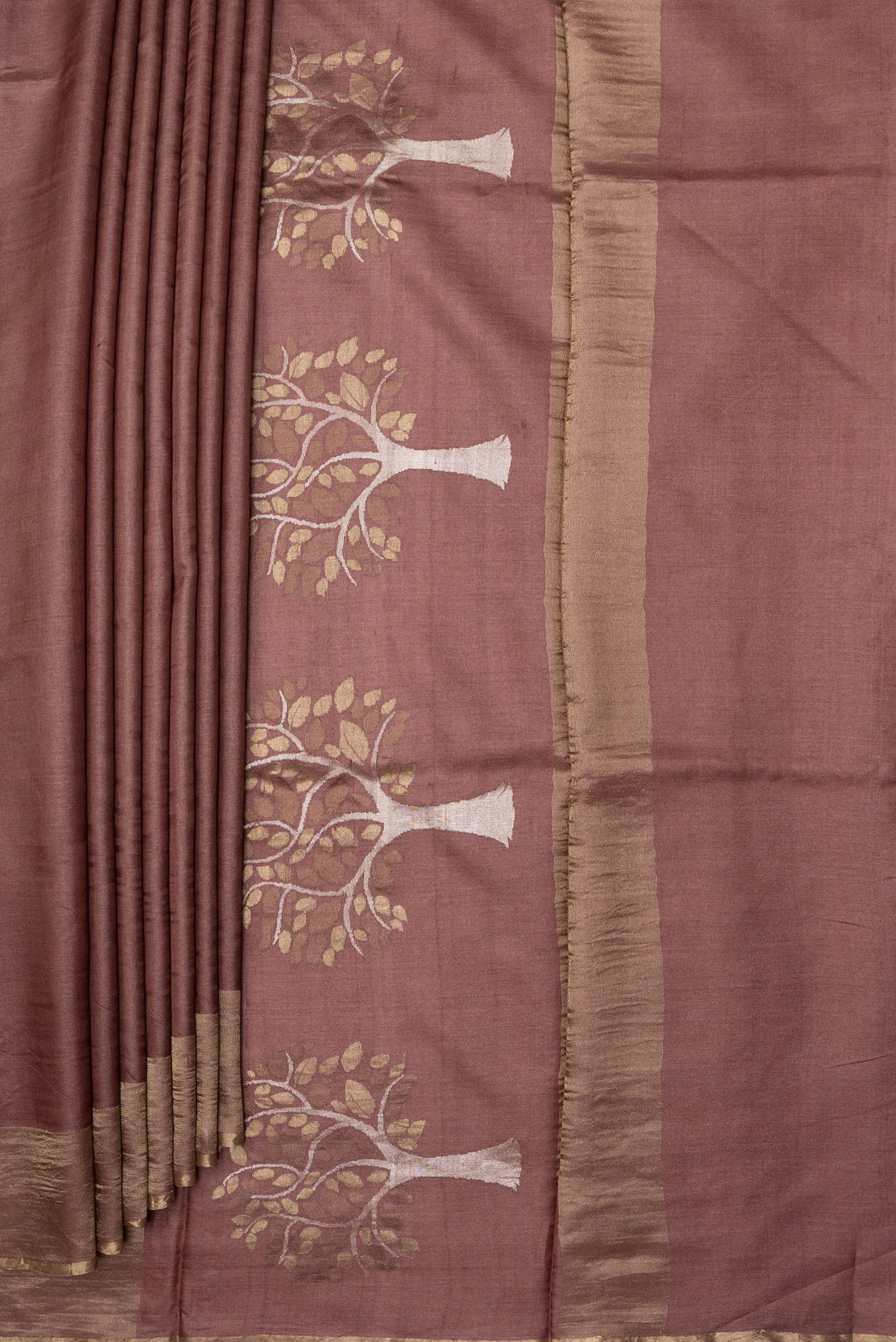 Pleats and pallu of Brown Tussar Silk Saree with Plain Body and Zari Border. 