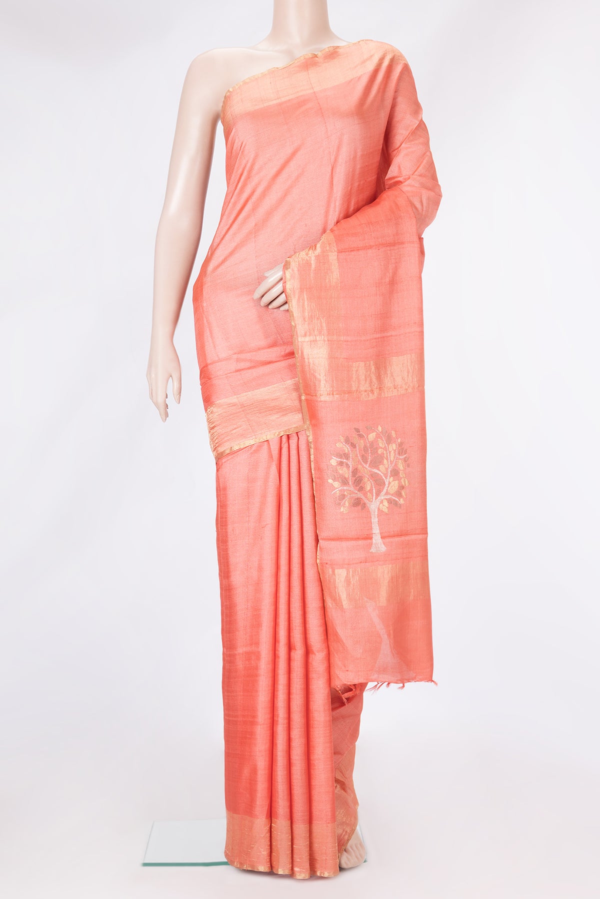 Peach Tussar Silk Saree with Plain Body and Zari Border.  displayed on a mannequin