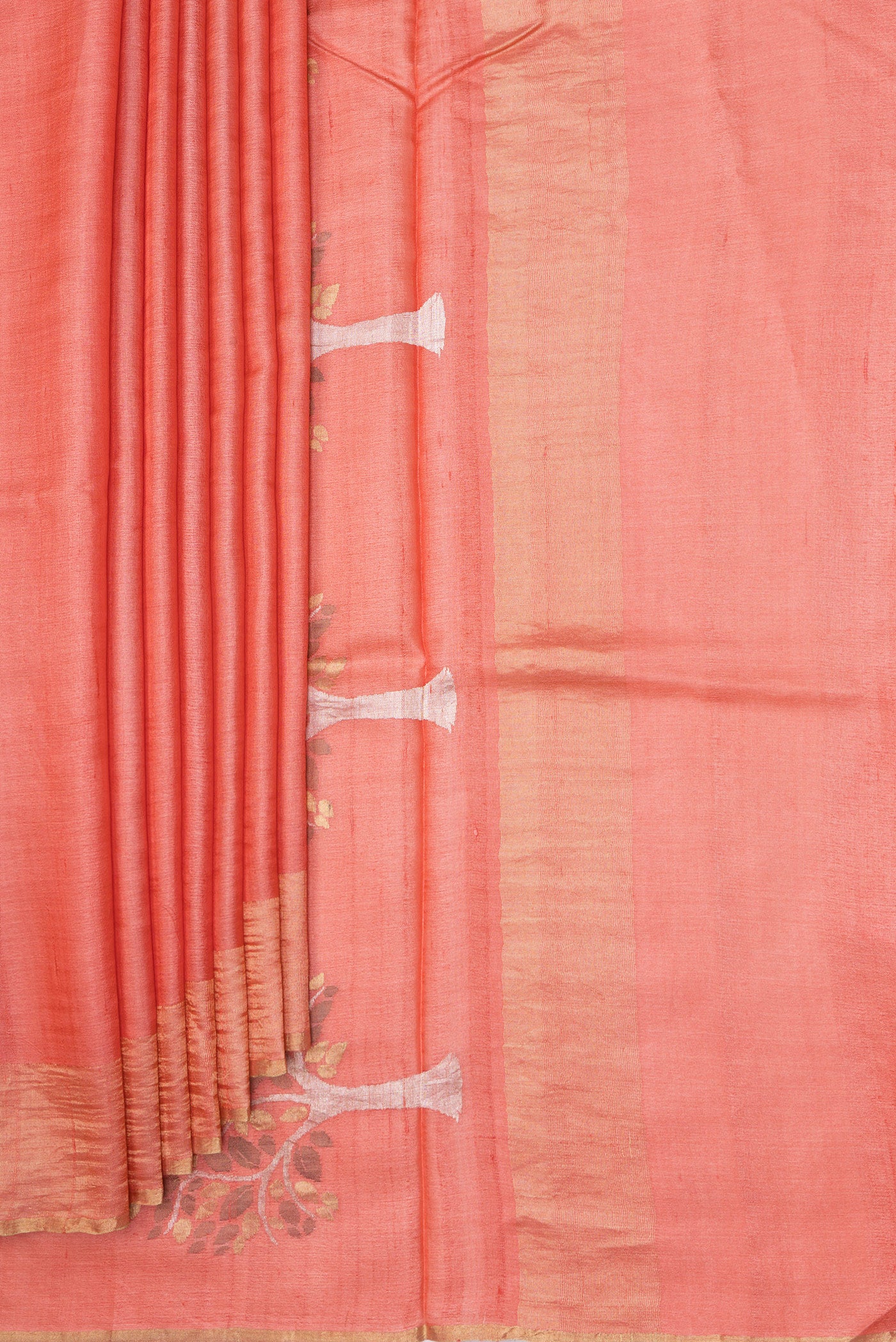 Pleats and pallu of Peach Tussar Silk Saree with Plain Body and Zari Border. 