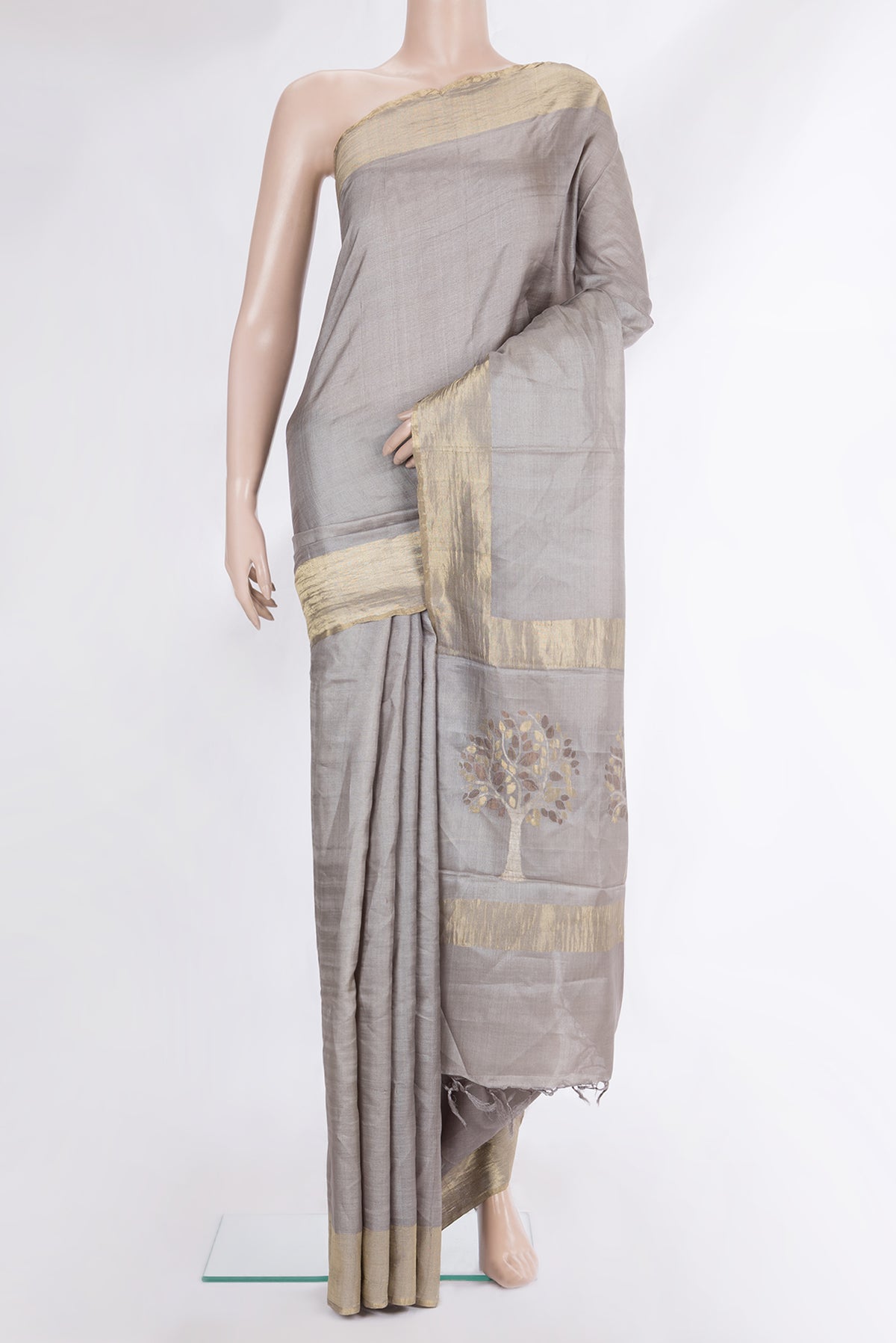 Pure Silk Grey Tussar Saree with Plain Body and Zari Border.  displayed on a mannequin
